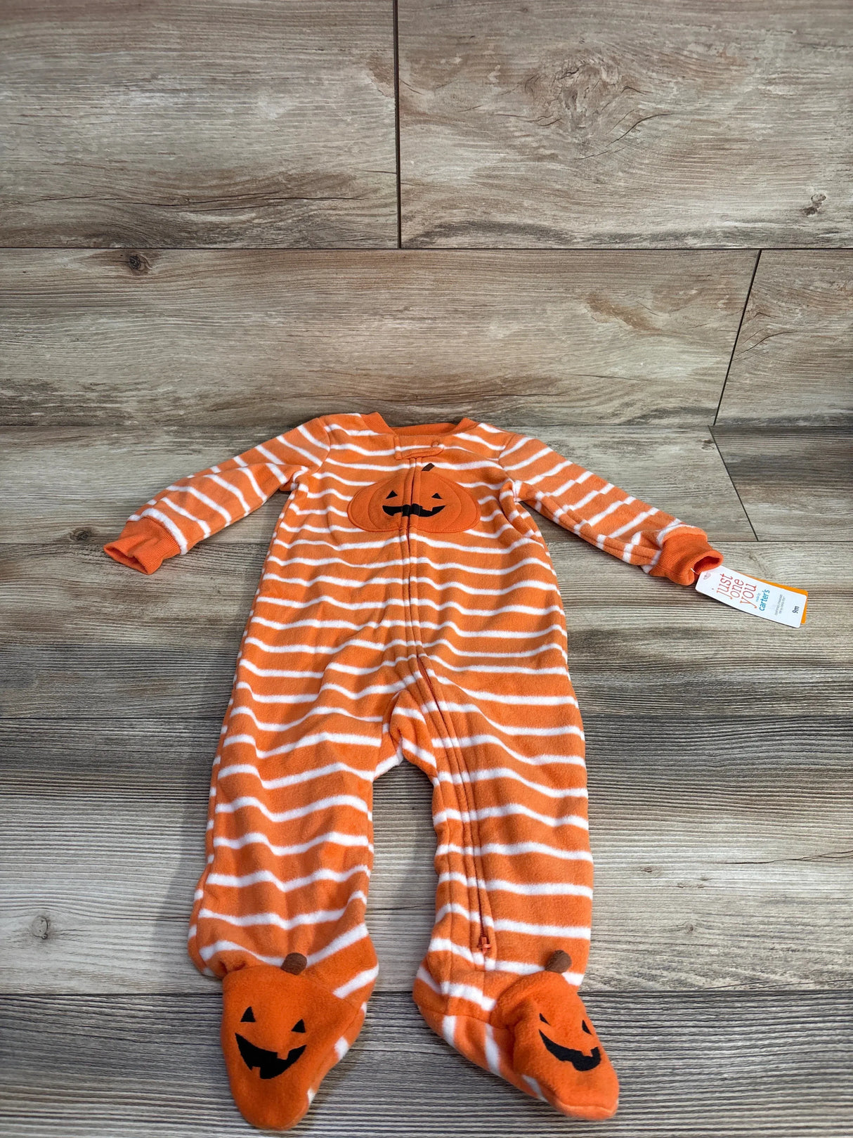 Orange and white striped baby Halloween onesie with pumpkin feet and face