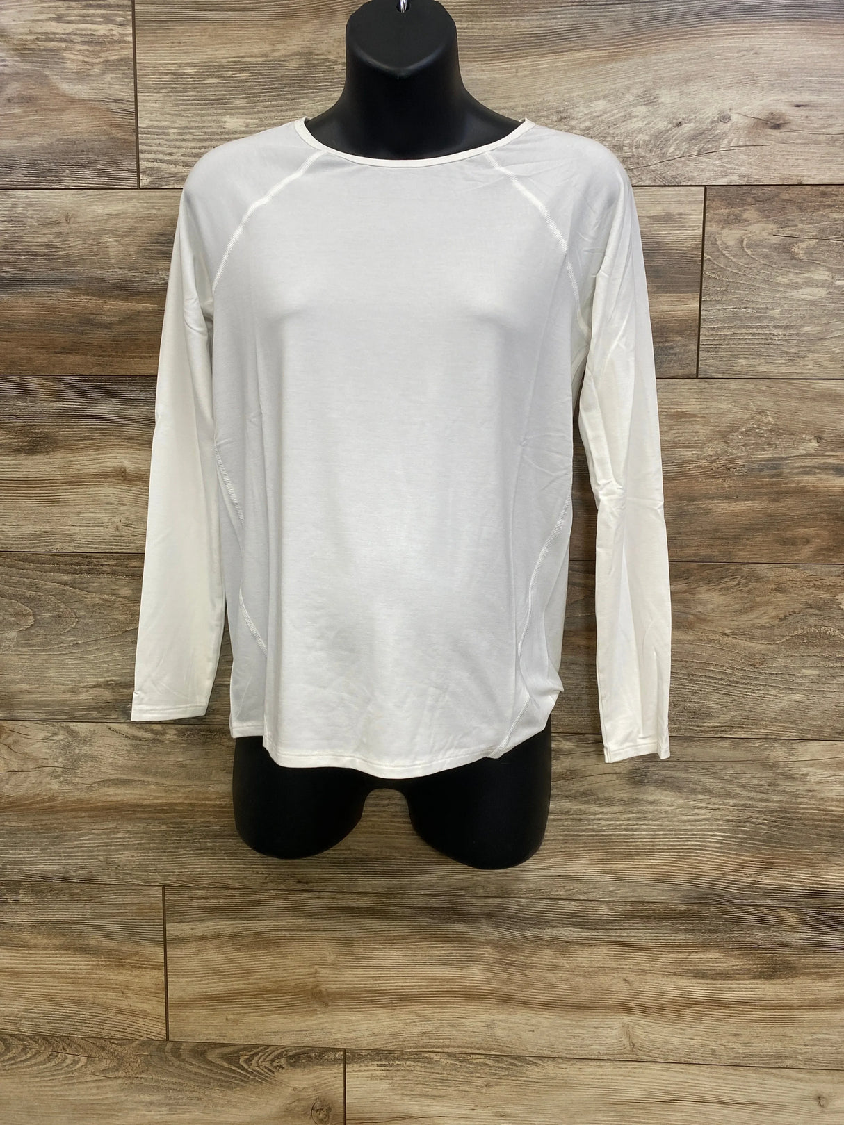 Front view of Gap maternity long-sleeve white Breathe shirt with raglan seams and relaxed fit on black mannequin against wood backdrop