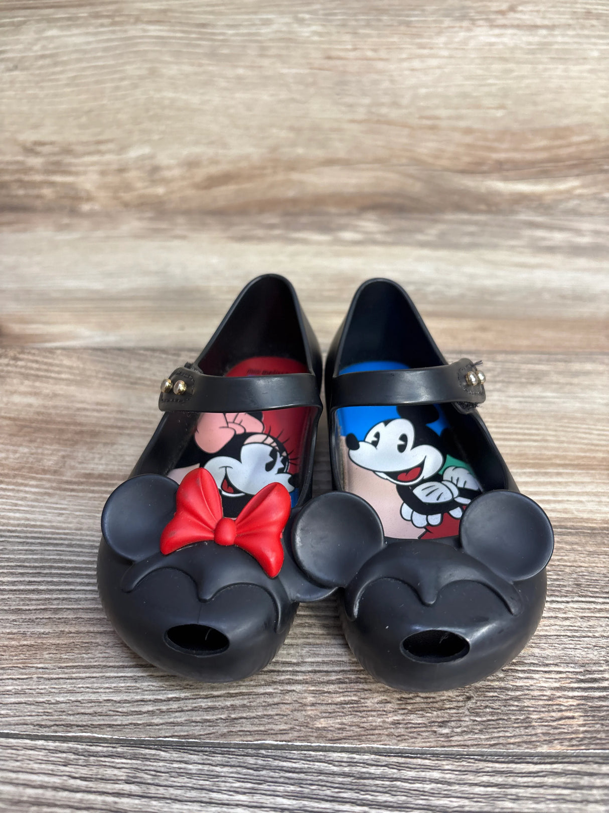 Black Mary Jane shoes with Minnie and Mickey Mouse faces, red bow on Minnie, cartoon insoles