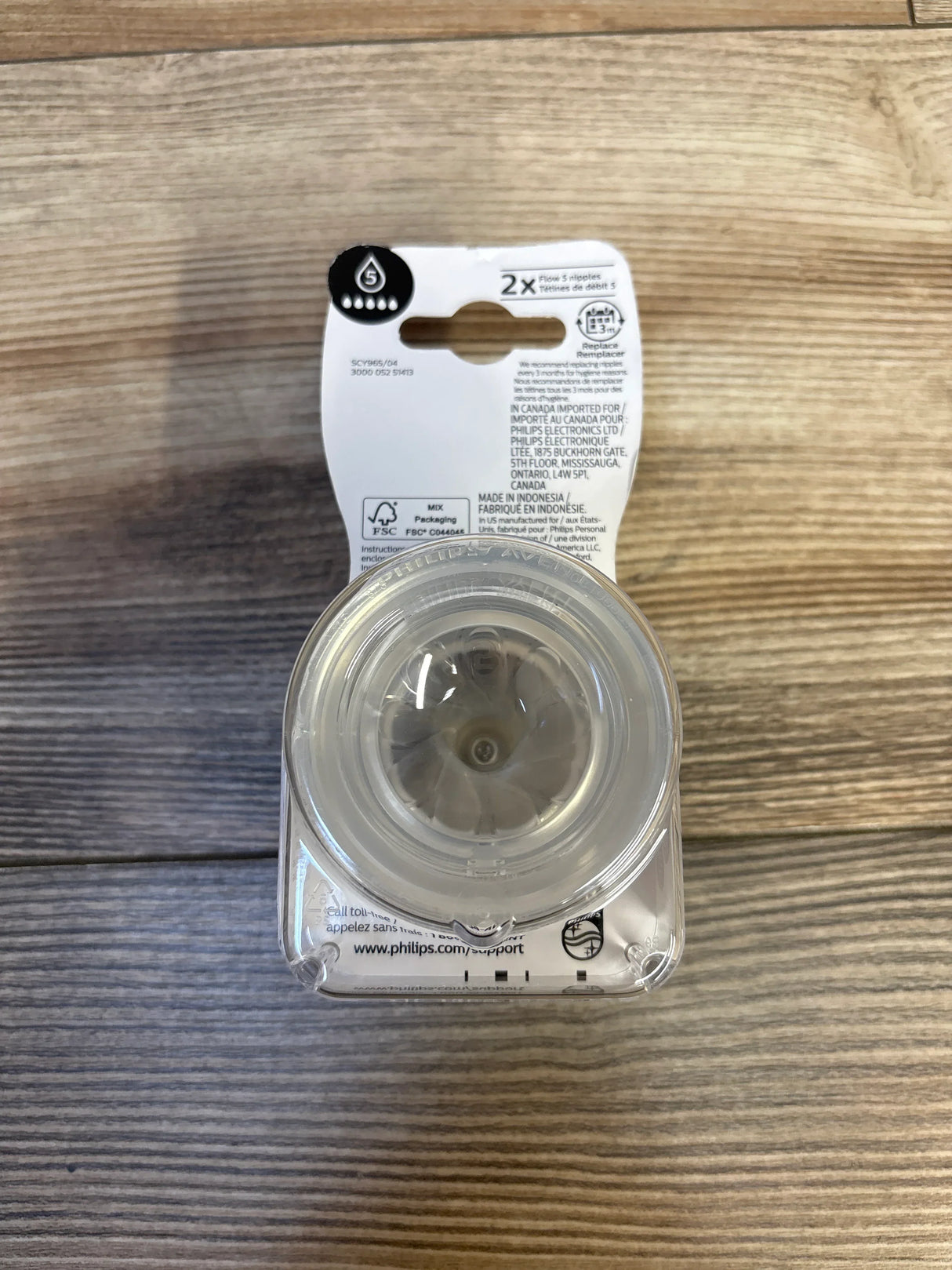 Pack of two clear baby bottle nipples on wood background, baby feeding accessory