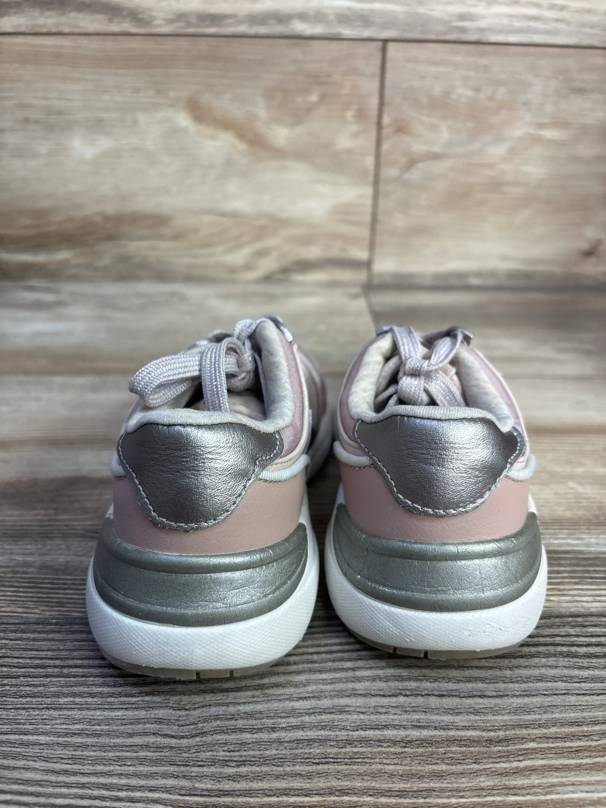 Rear view of Mayoral Makeup Sneakers showcasing pink and metallic gray panels, gray laces, and white soles on a wood floor