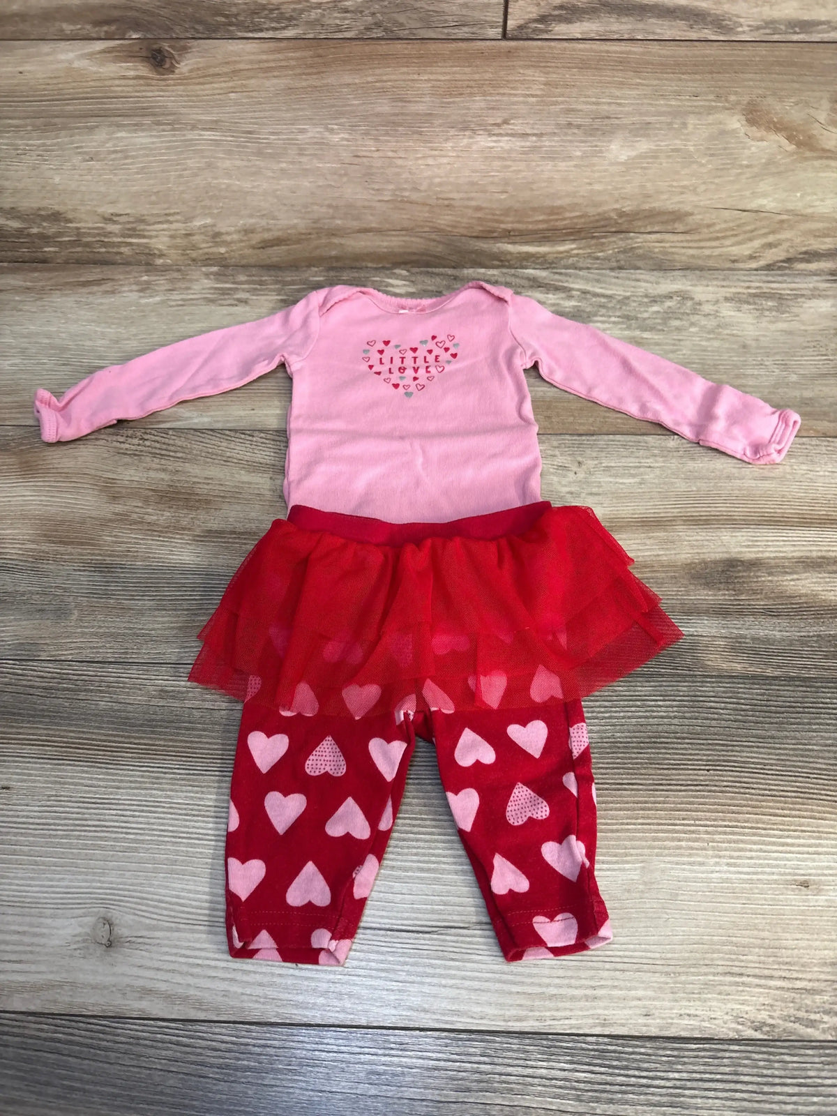 Pink and red baby girl outfit with heart print leggings, tutu skirt, and long sleeve onesie