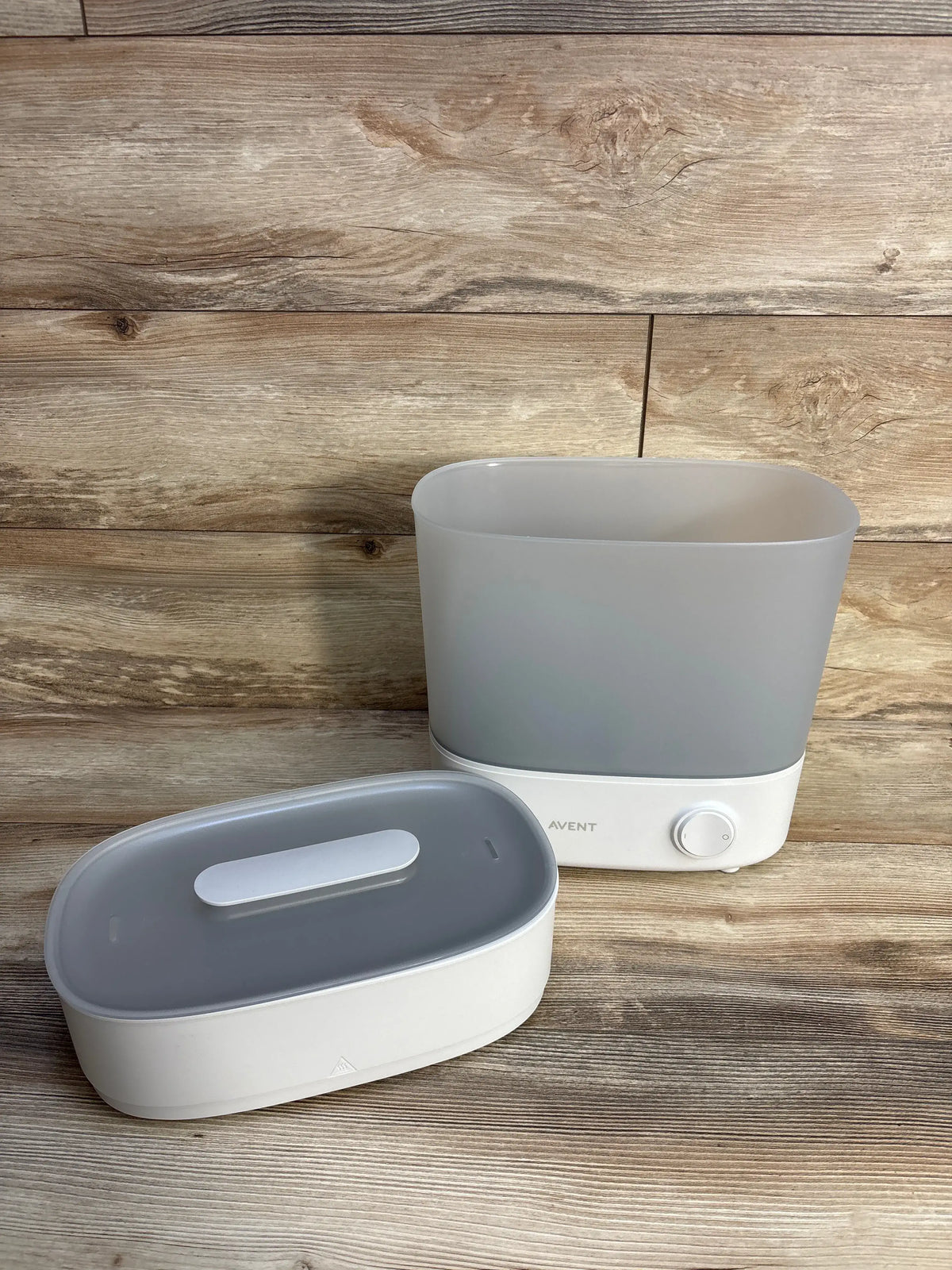 Front view of Philips Avent Advanced Electric Steam Sterilizer showcasing its white two-piece design on a wood surface