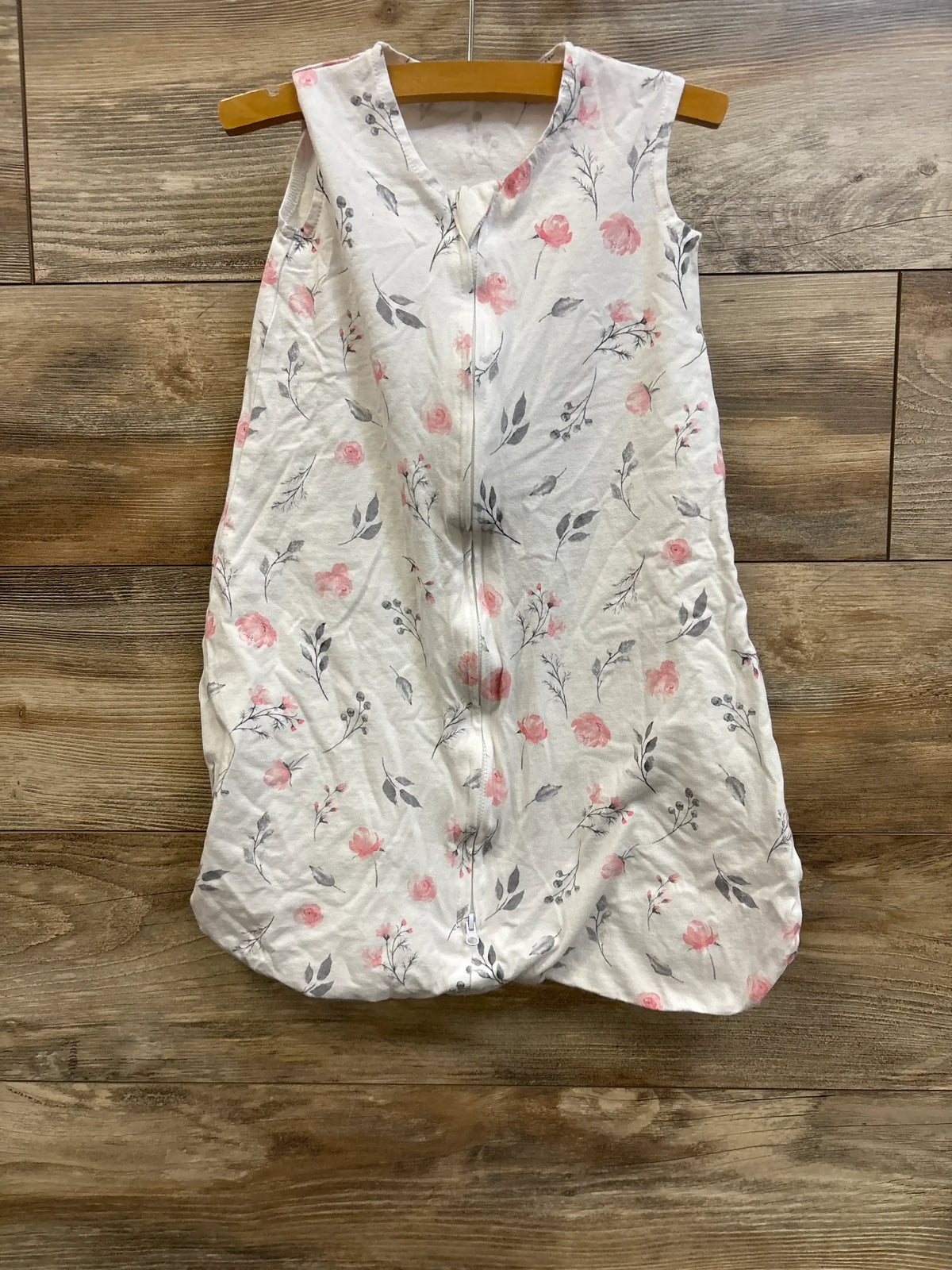 White floral print sleep sack for infants by Me n Mommy To Be hanging on a wooden hanger.
