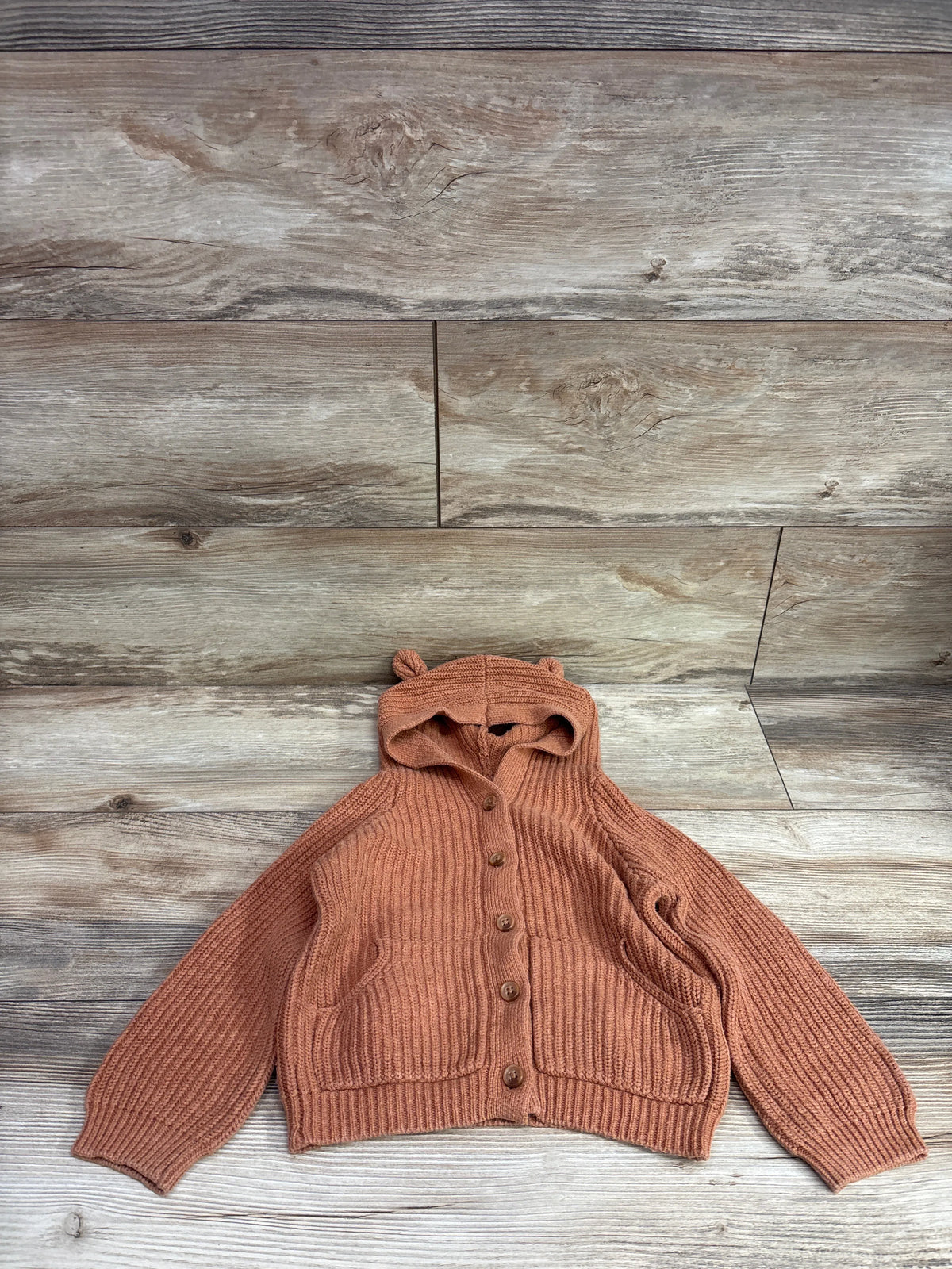 Butterscotch knit bear hoodie cardigan for toddlers by Me n Mommy To Be on a wood background