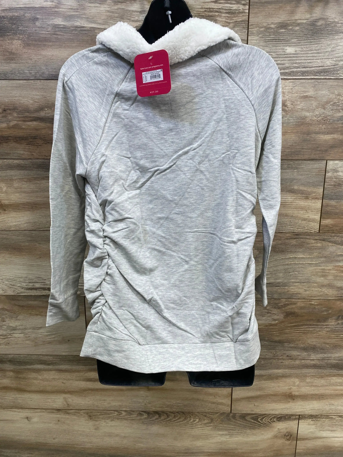Back view of grey Isabel maternity sweatshirt showcasing sherpa-lined collar and side ruching on wooden backdrop