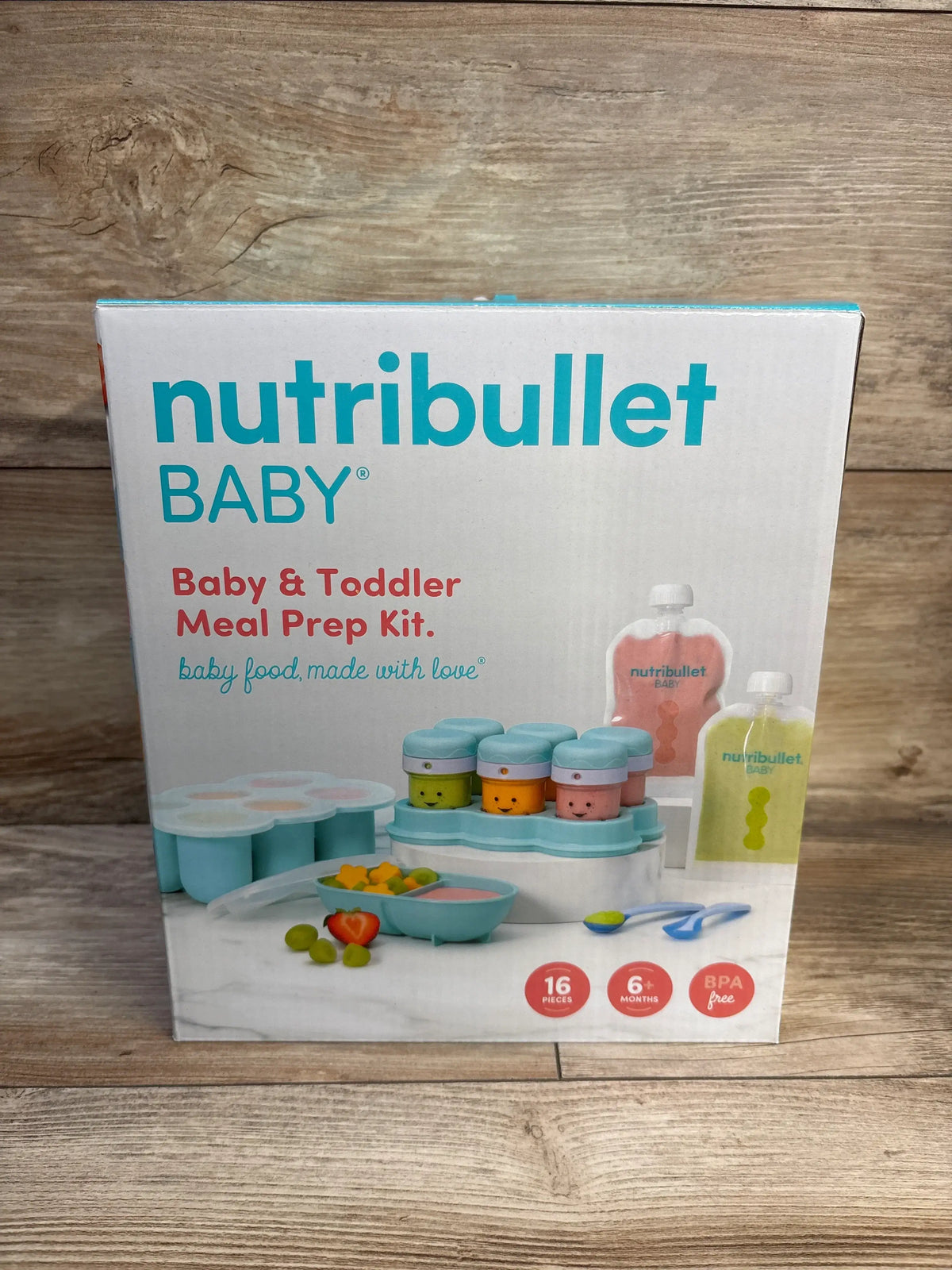 Front view of NutriBullet Baby & Toddler Meal Prep Accessory Kit box showing pouches, storage cups, spoons, bowl, and freezer tray