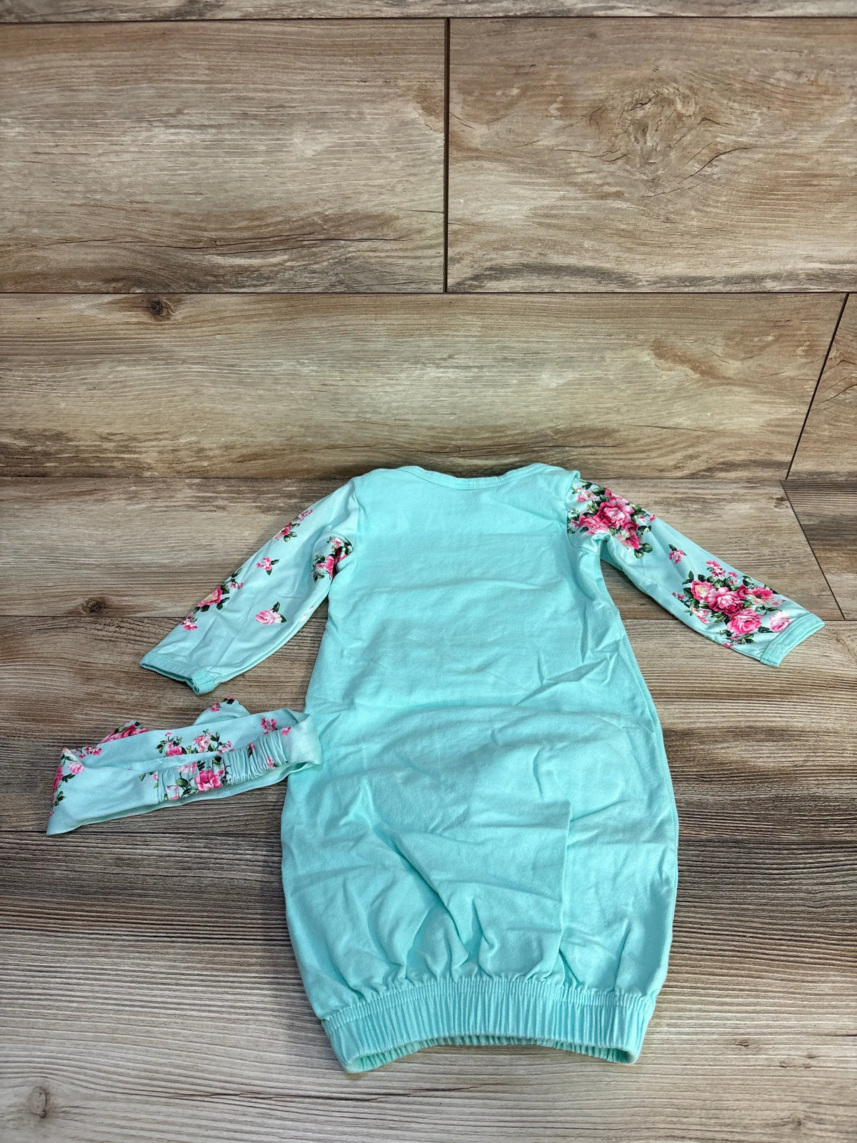 Front view of Little Sis blue sleep gown and headband set for ages 6 to 9 months, showcasing floral sleeves on wood grain