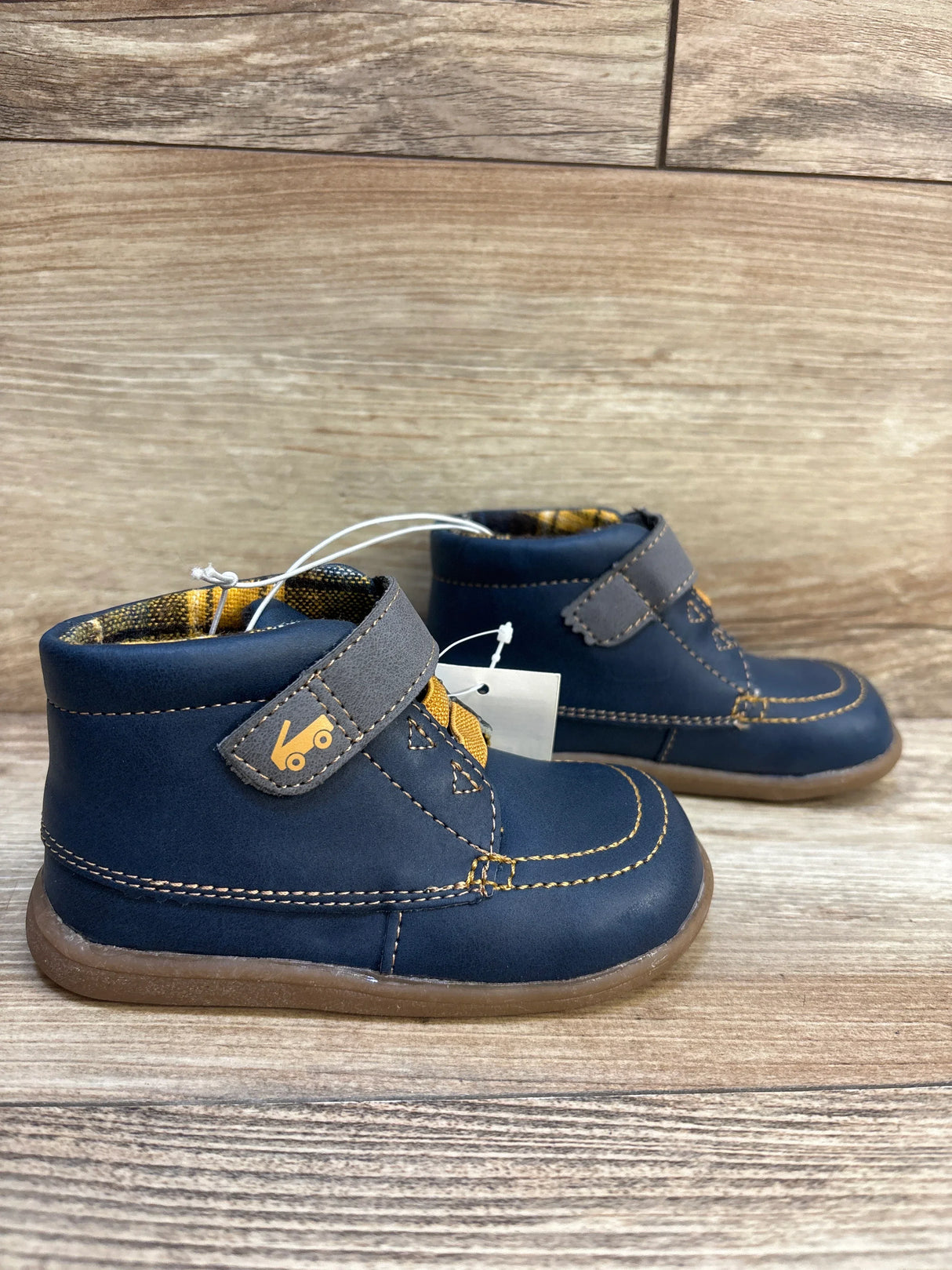 Navy blue toddler boots with yellow stitching and Velcro straps, new with tags