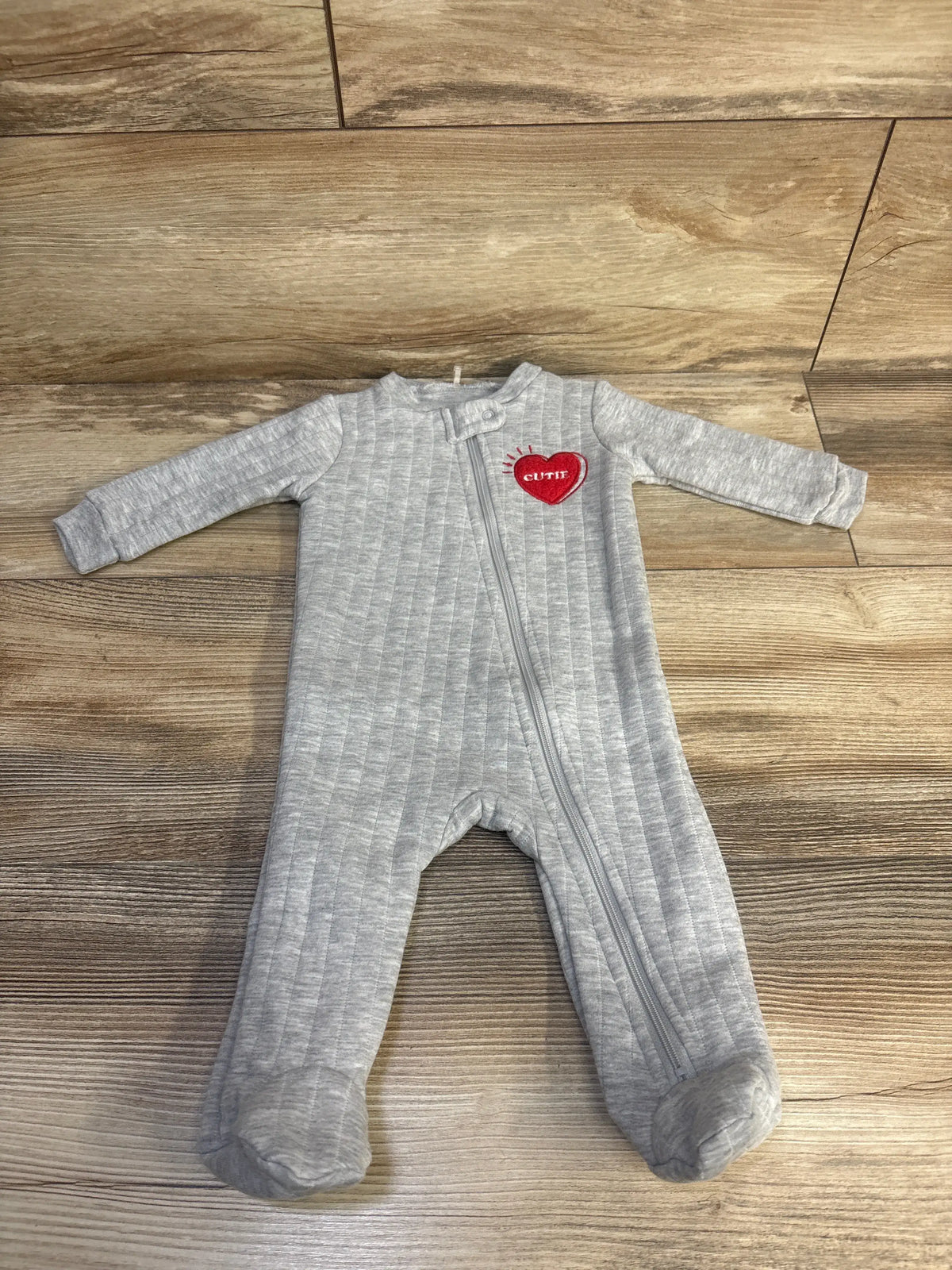 Front view of grey Kyle + Deena quilted sleeper with vertical quilting, long sleeves, footed legs, and front zipper