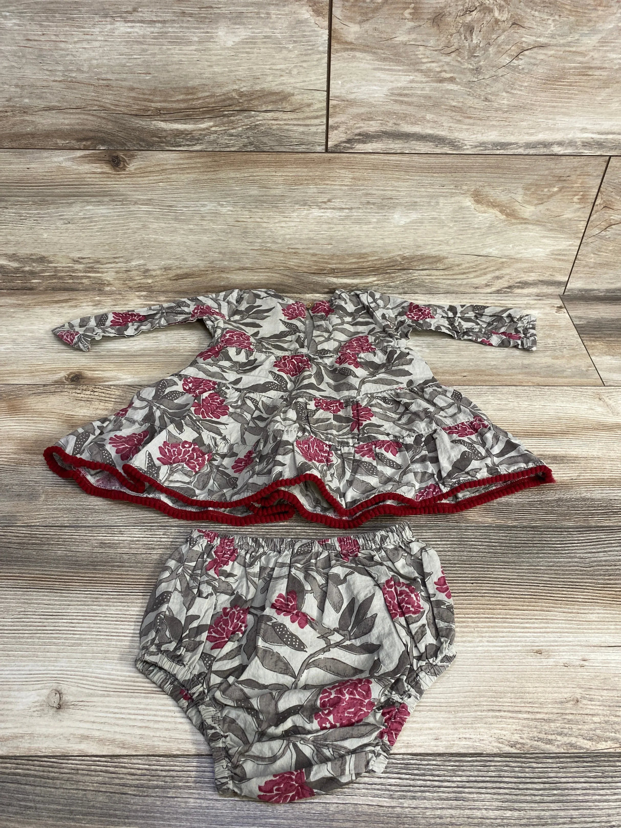 Baby long sleeve floral dress and matching bloomers in gray and red on wood background