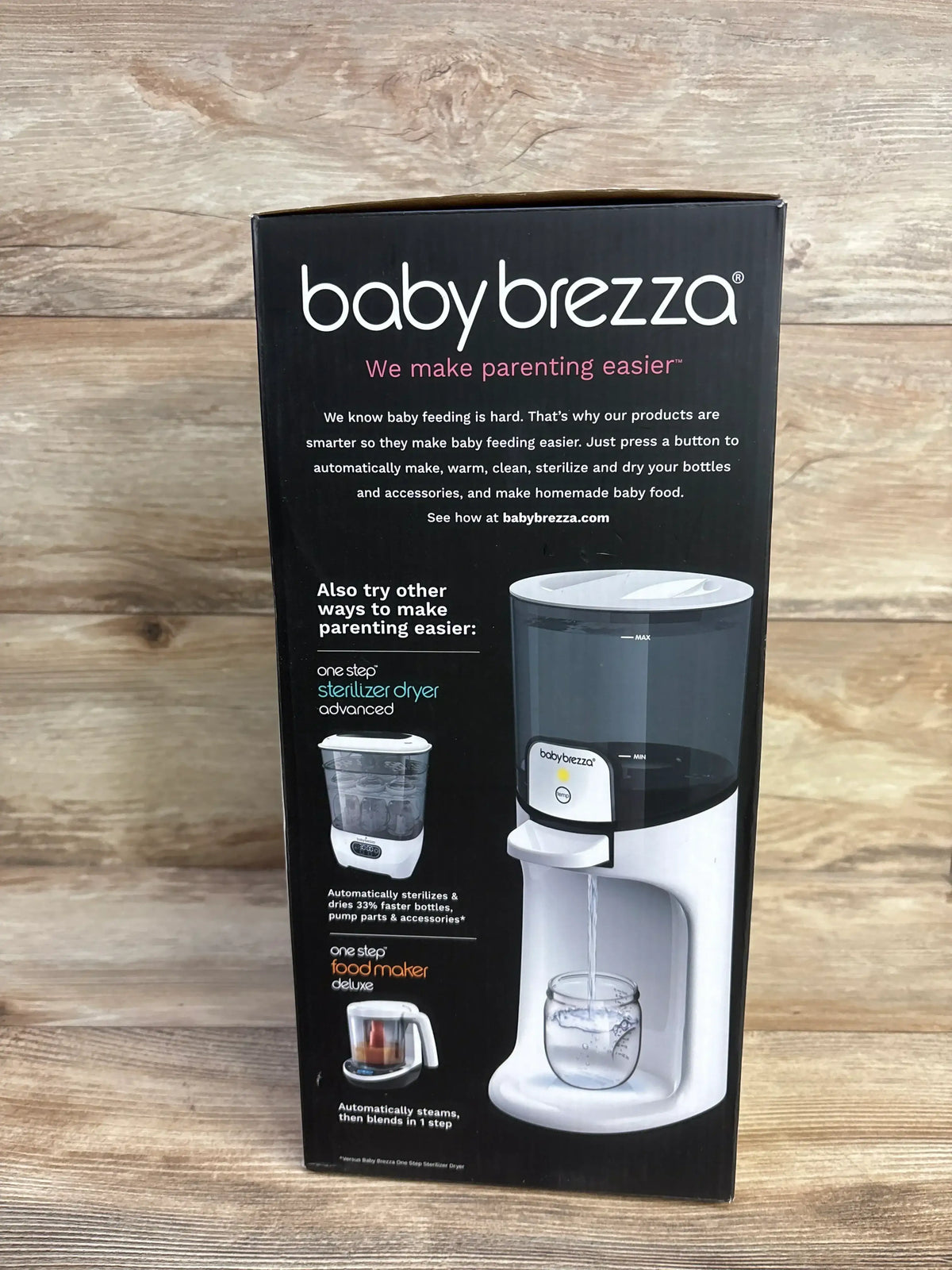 Front view of Baby Brezza bottle warmer box showing warmer pouring water into a jar and headline 'We make parenting easier'
