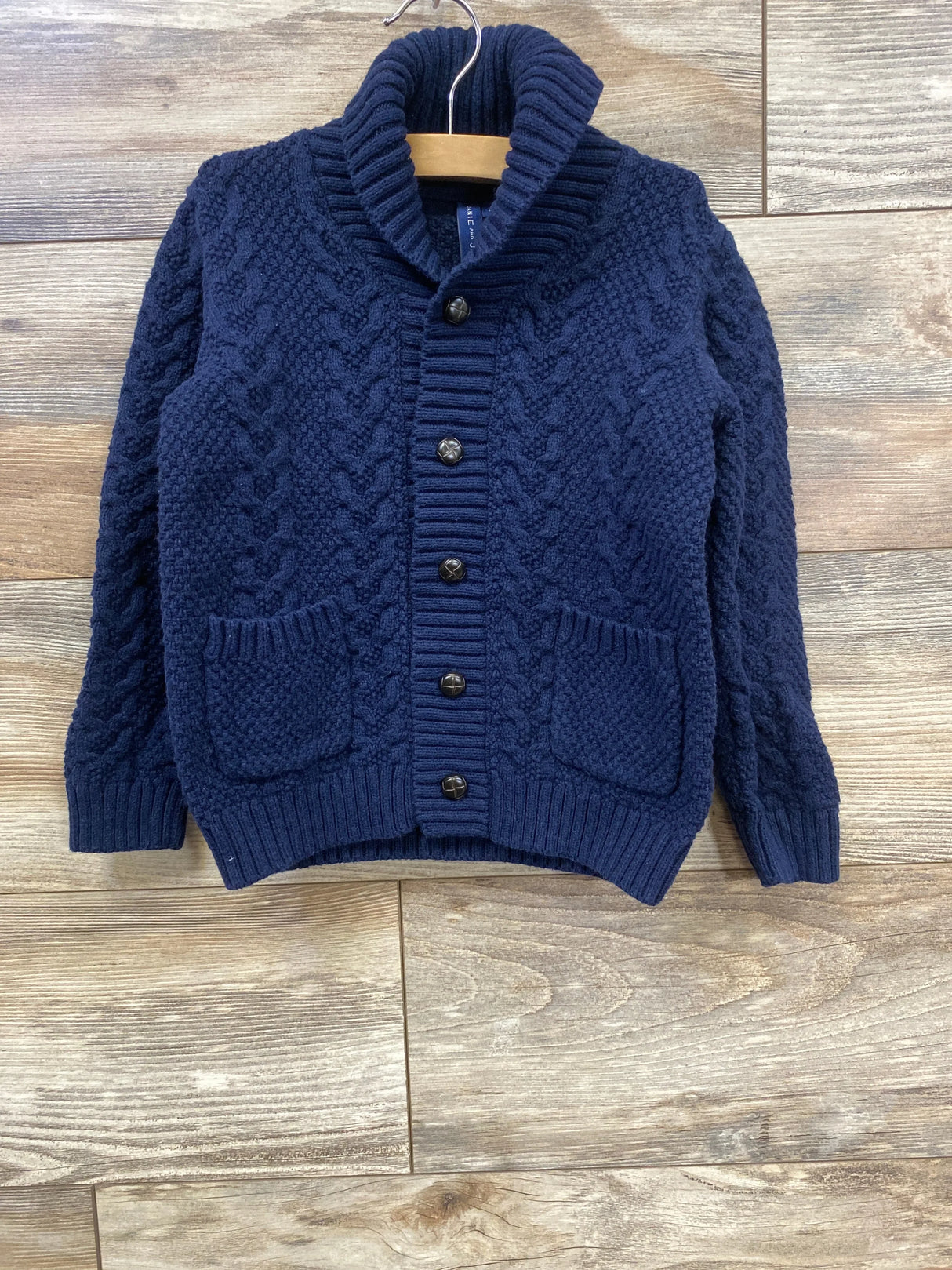 Navy blue cable knit toddler cardigan sweater with buttons and front pockets