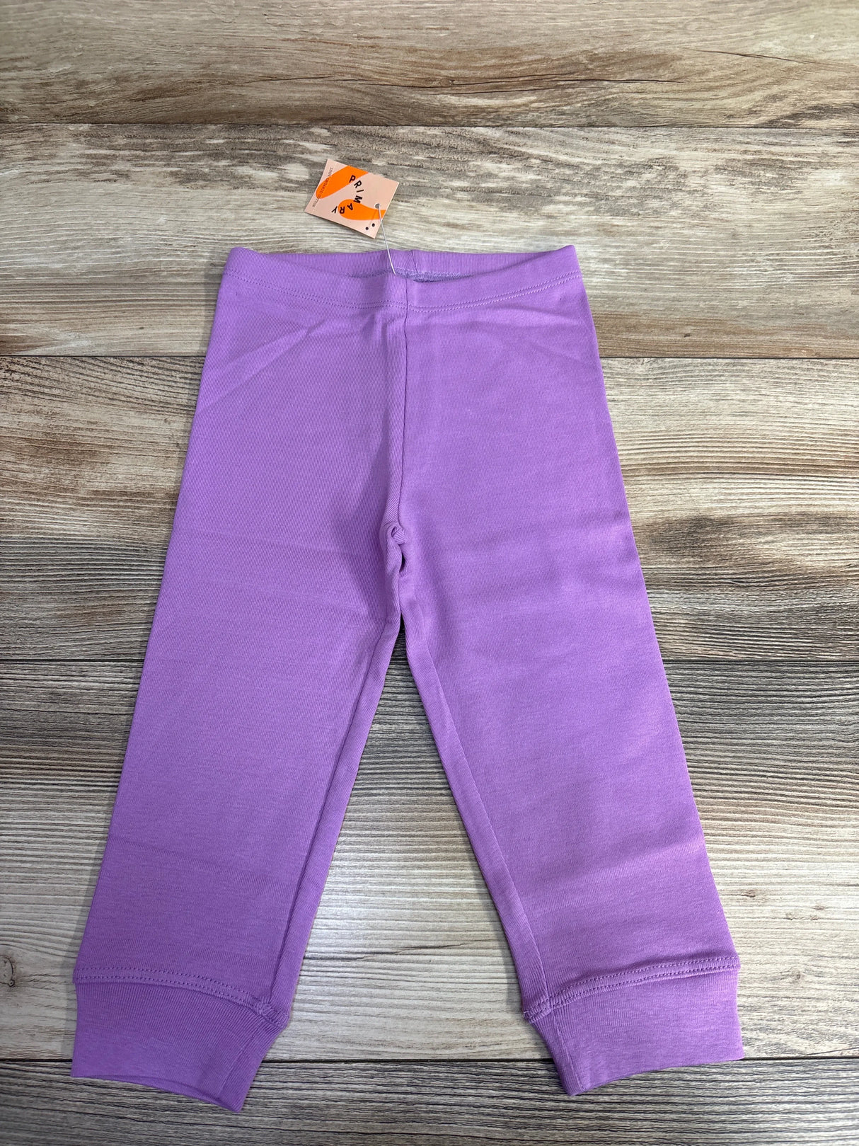 Kids lilac purple cotton leggings with cuffs on wood background, new with tags