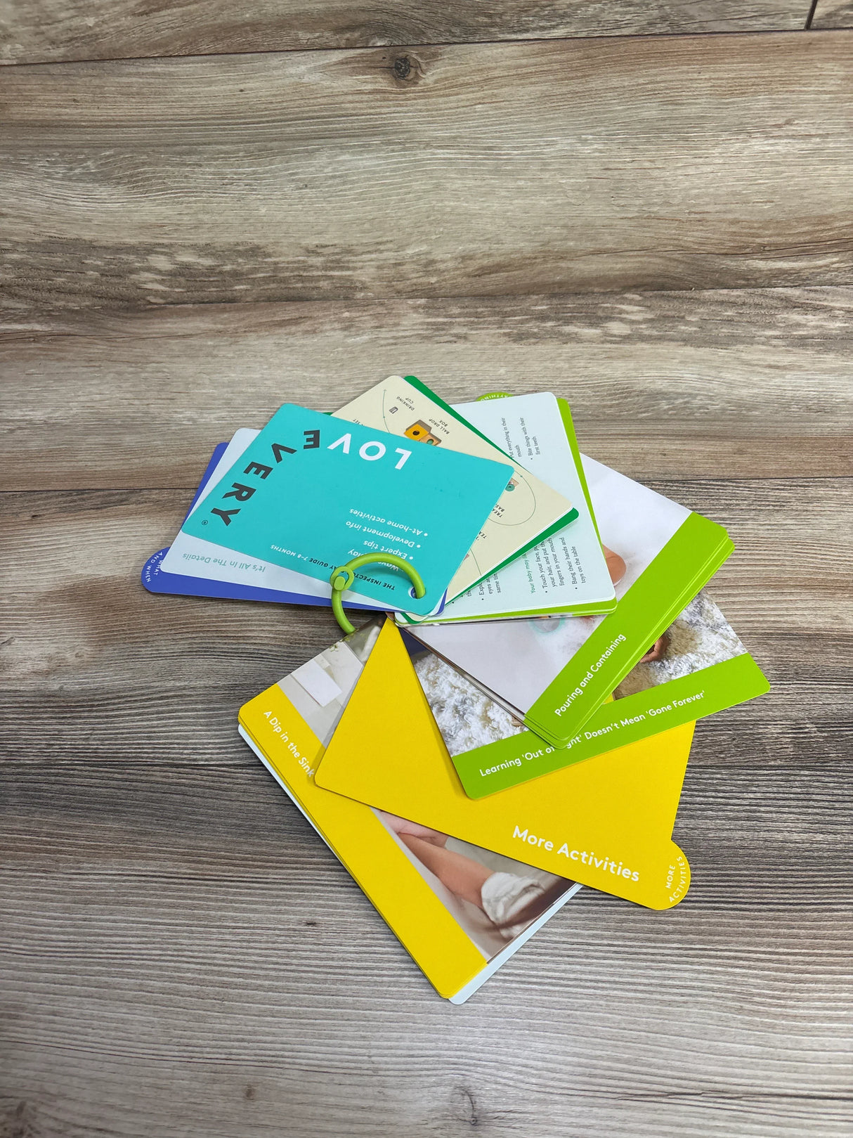 Lovevery activity cards on wood surface, colorful educational flashcards for kids