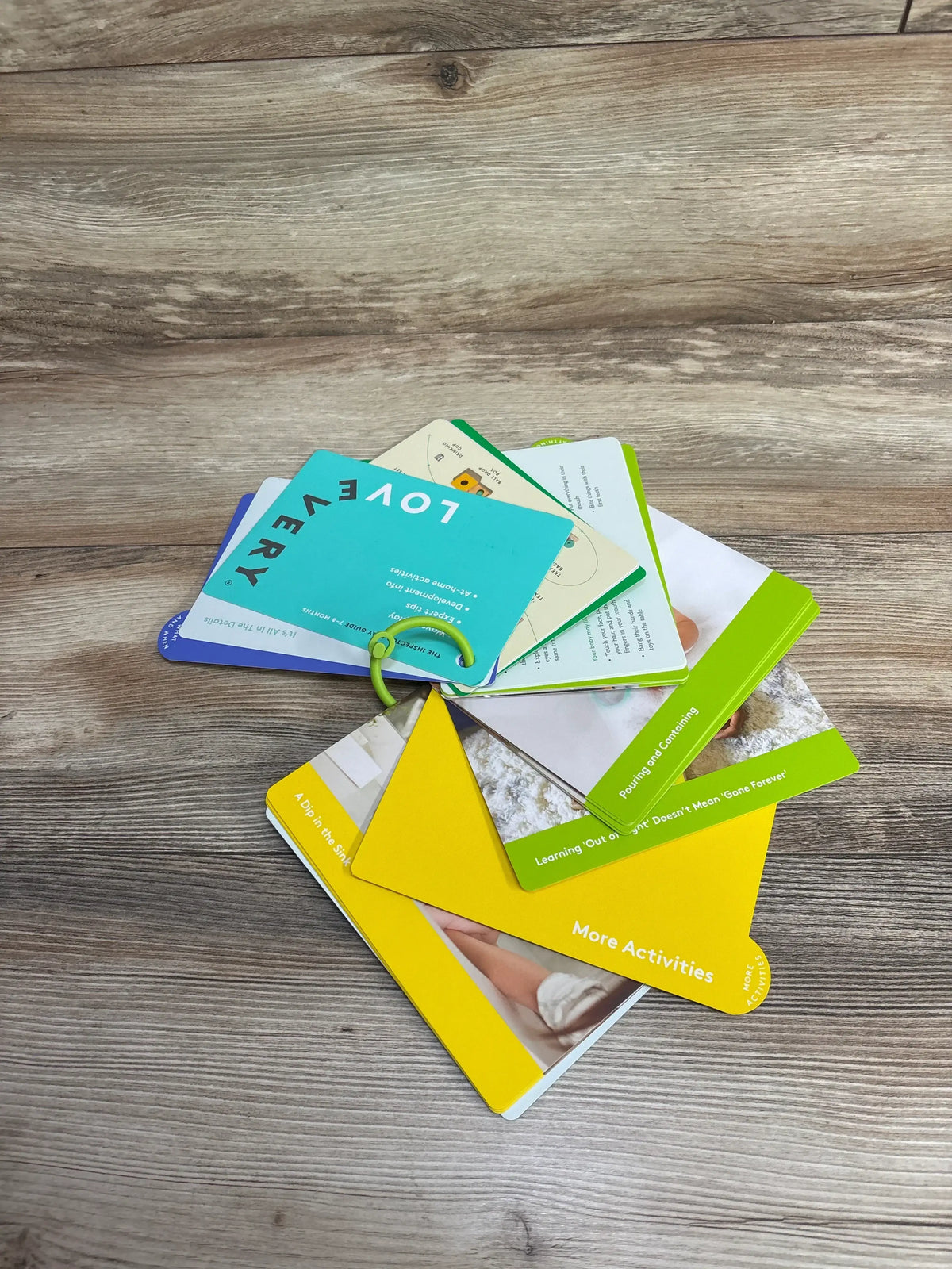 Lovevery activity cards on wood surface, colorful educational flashcards for kids