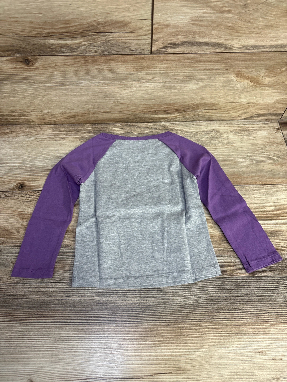 Gray shirt with purple long sleeves on wood background, kids raglan tee