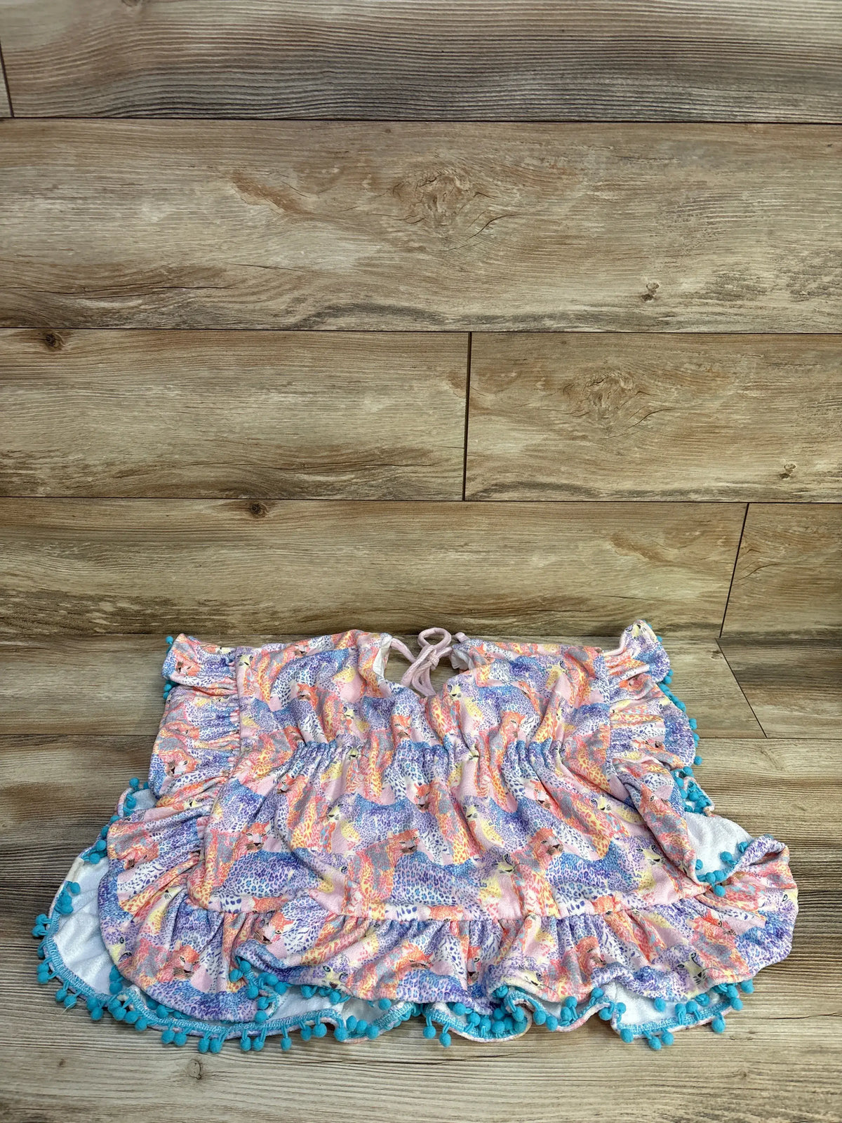 Front view of Cheeky Plum Ruffle Swim Cover in Wild One sz 4/5T showcasing ruffles and pom pom trim