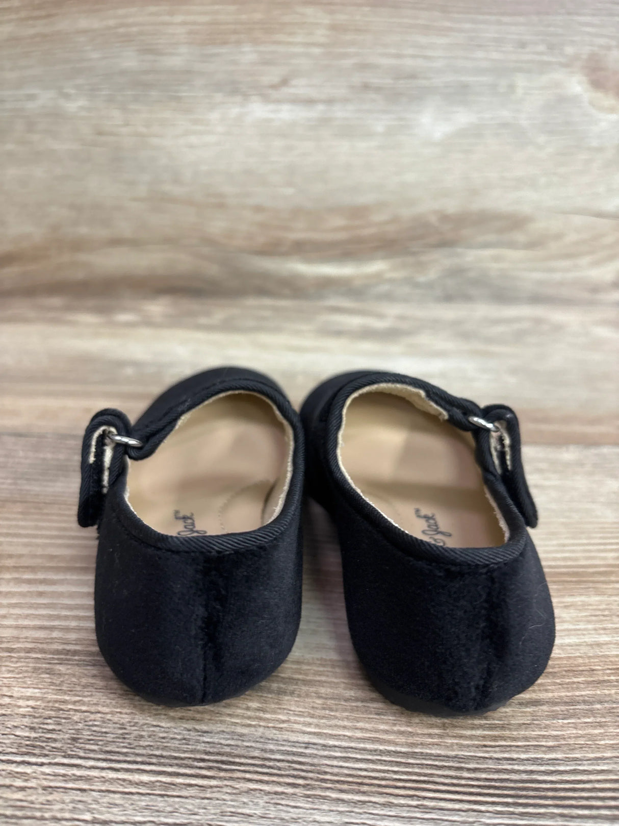 Front view of Cat & Jack velvet ballet flats size 6C showcasing Mary Jane strap and rounded toe on light wood background