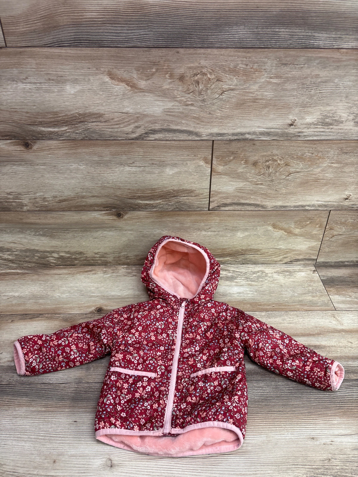 Flat lay of Penelope Mack red floral fur-lined jacket, size 18 months, with pink lining, hood, zipper, and pockets