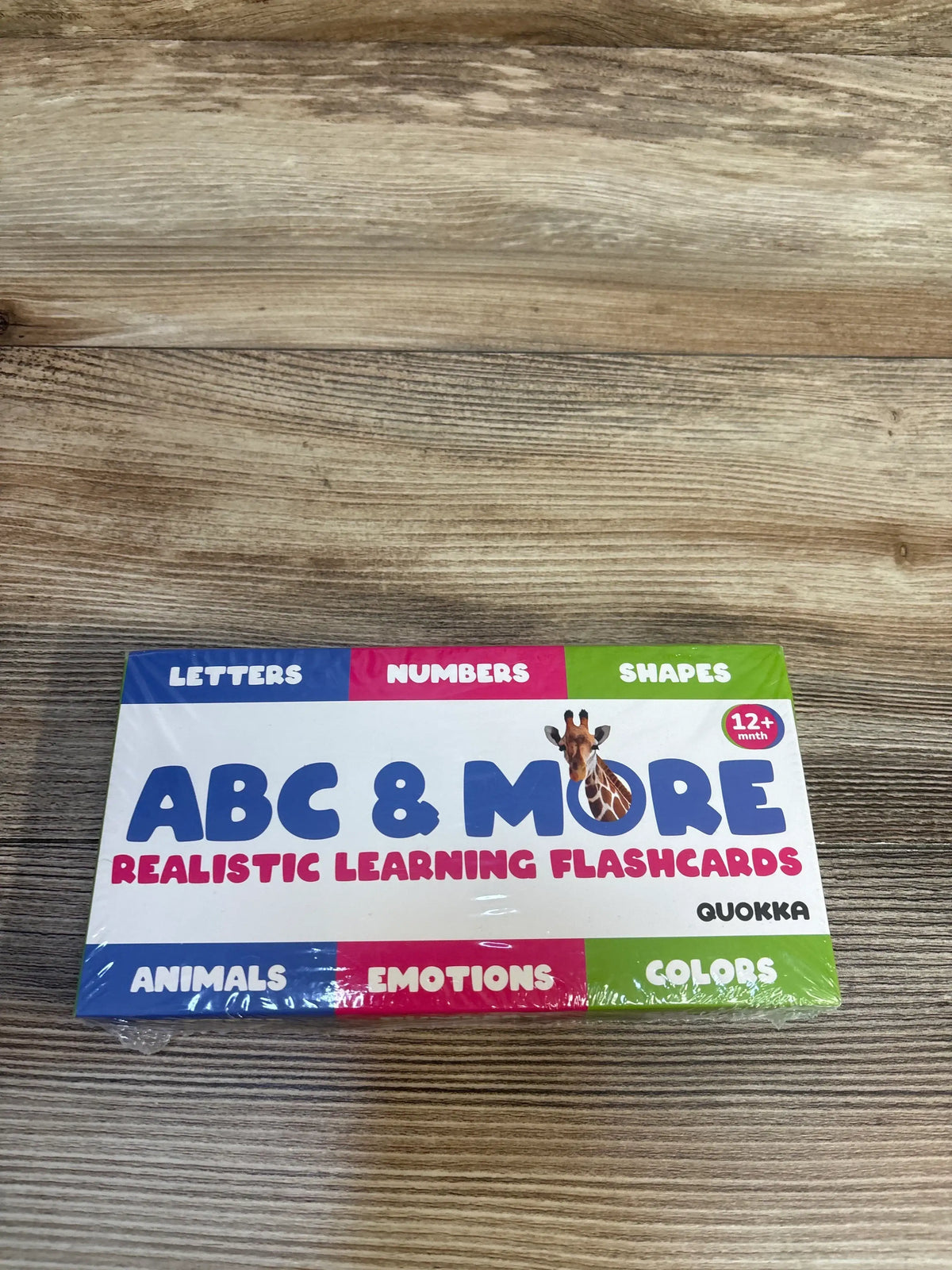 Quokka ABC and More 60 count flashcards box with headline ABC and MORE and panels for letters numbers shapes on wood surface