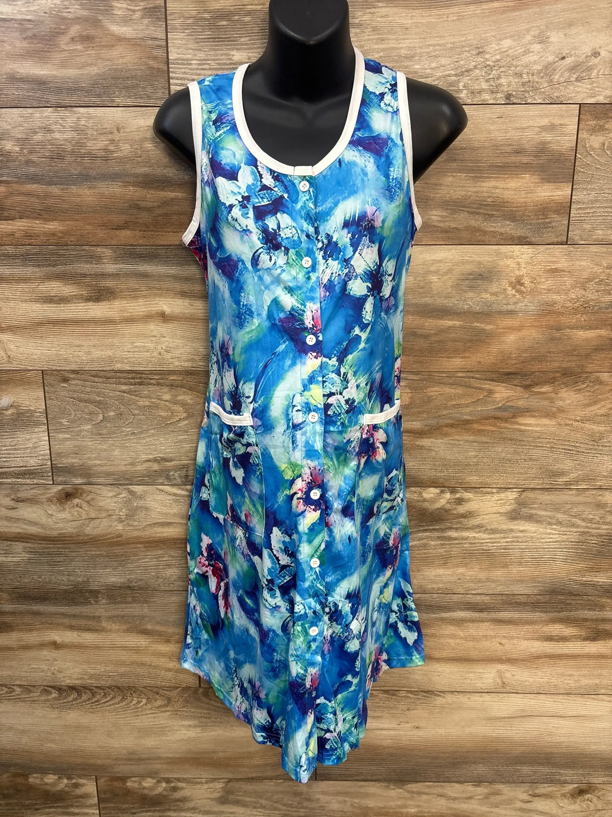 Front view of new Ekouaer floral tank dress size Medium in blue floral print with white trim and button front on black mannequin over wood plank floor