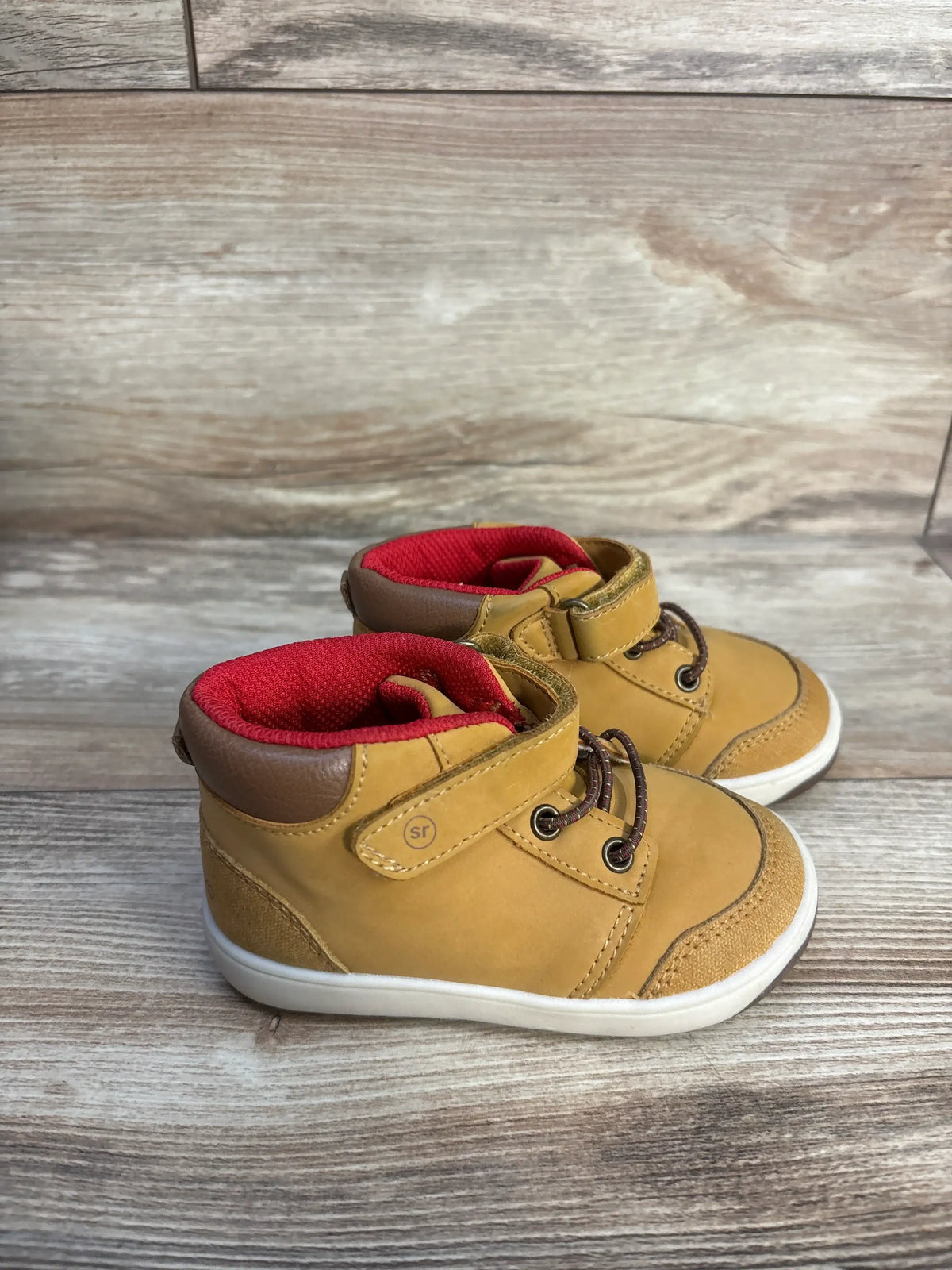 Front and side view of Stride Rite 360 Indiana Honey Yellow sneaker boots, size 6C, showcasing hook and loop closures on wood