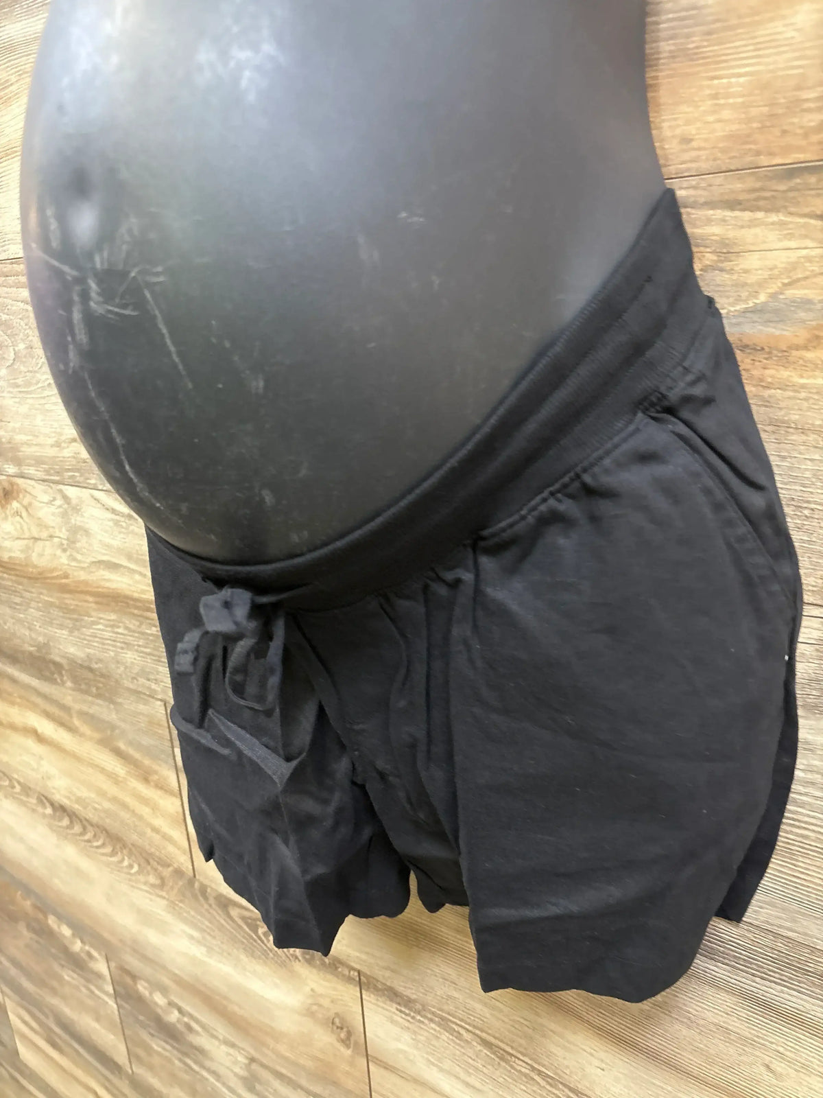 Front view of black Gap maternity linen-blend shorts showcasing under-belly elastic waist and drawcords on mannequin
