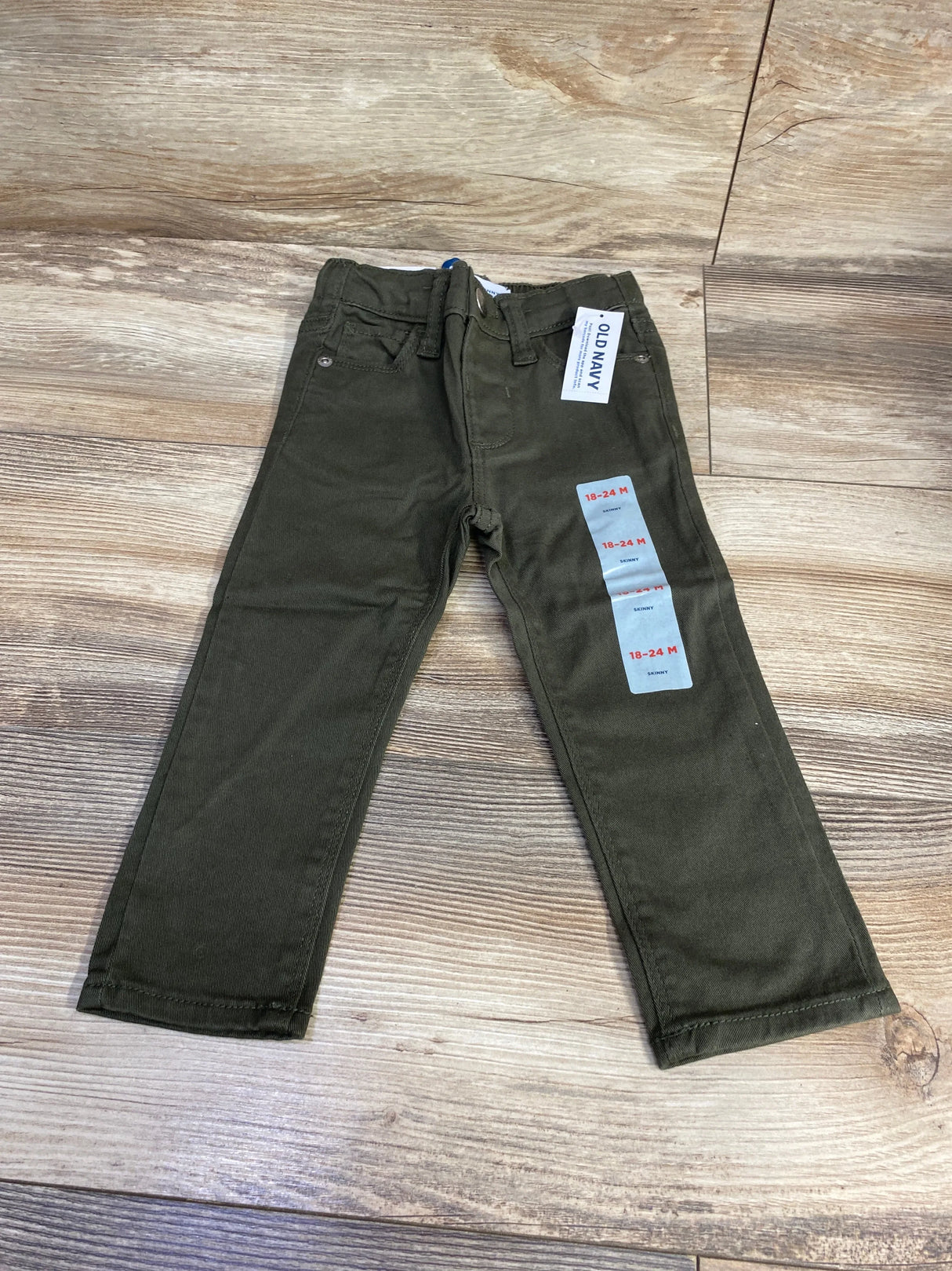 Olive green toddler pants size 18-24 months, labeled Old Navy, on wood floor