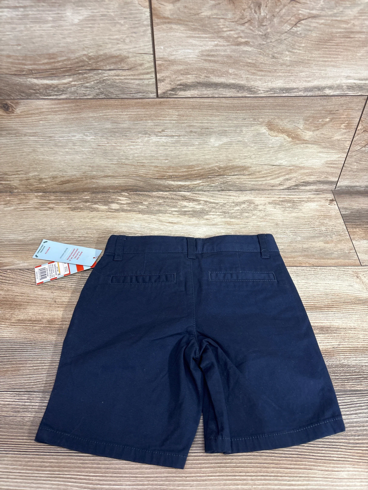 Front view of Cat and Jack navy toddler school uniform shorts showcasing elastic waistband and cuffed hem on white background