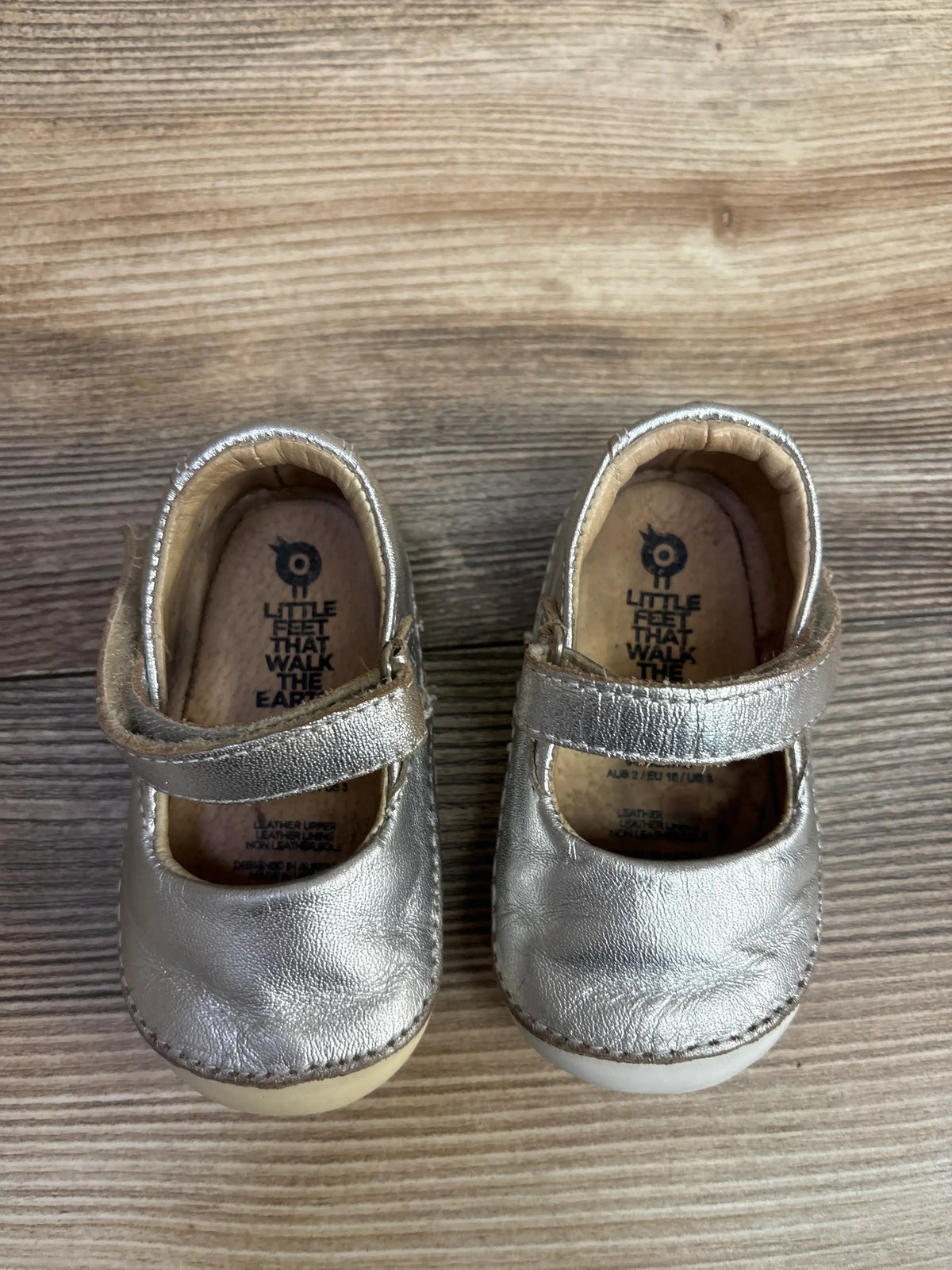 Silver leather toddler Mary Jane shoes with Velcro straps on wooden floor, kids resale footwear