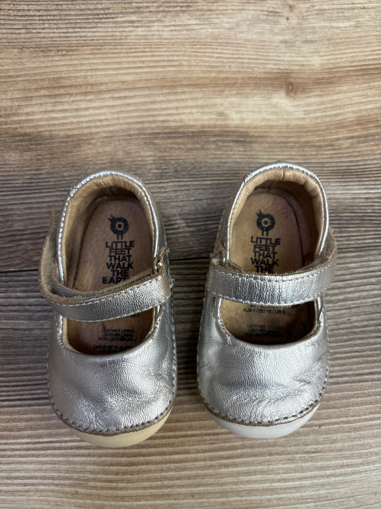 Silver leather toddler Mary Jane shoes with Velcro straps on wooden floor, kids resale footwear