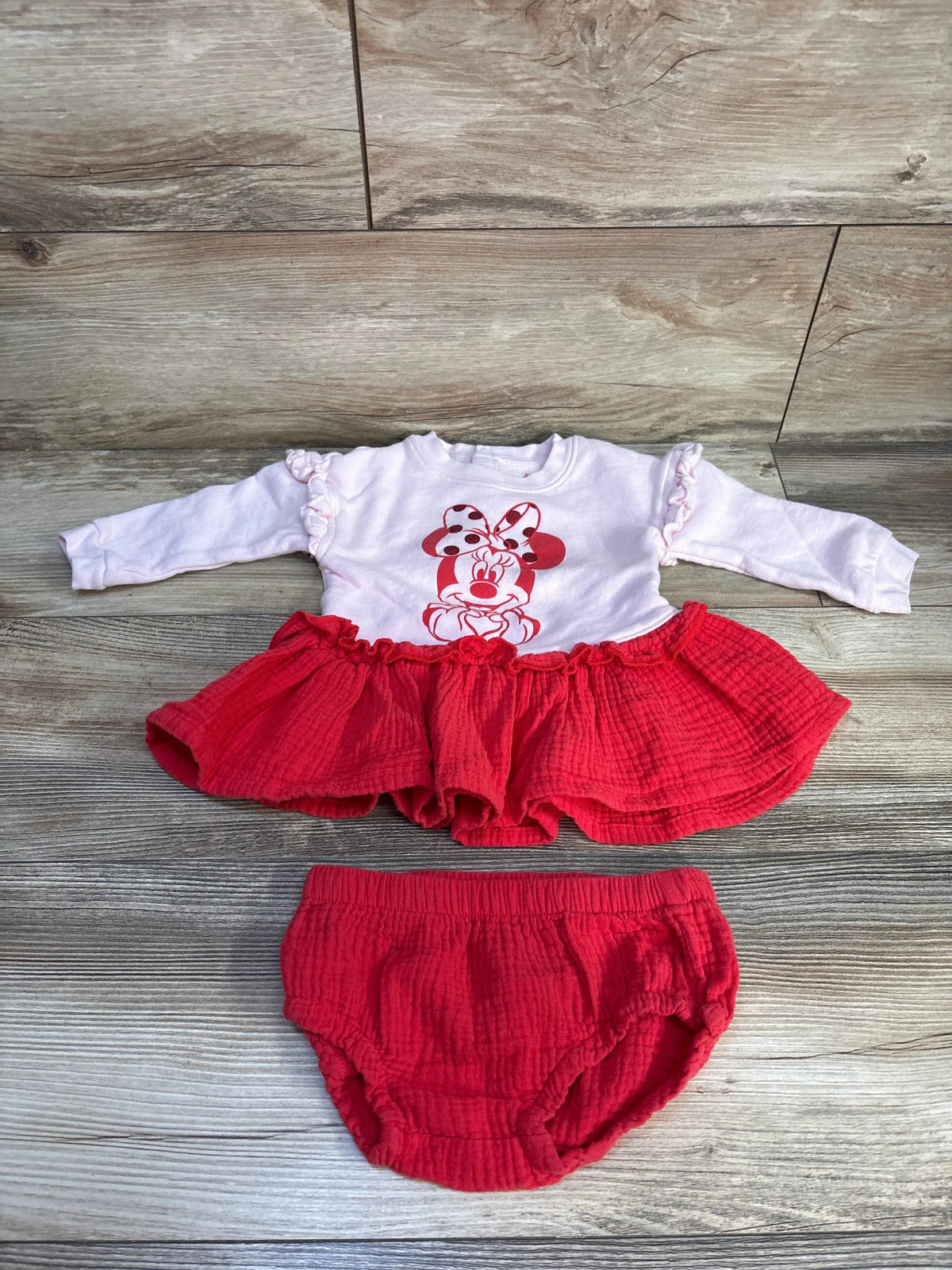 Disney Store Minnie Mouse two-piece gauze sweatshirt dress and bloomers with ruffled cuffs and red skirt on wood floor