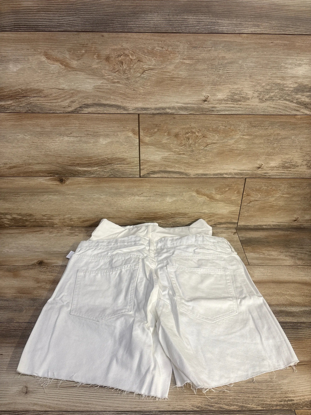 Rear view of white Gap maternity shorts showcasing full panel waistband, five pocket styling, and frayed hems