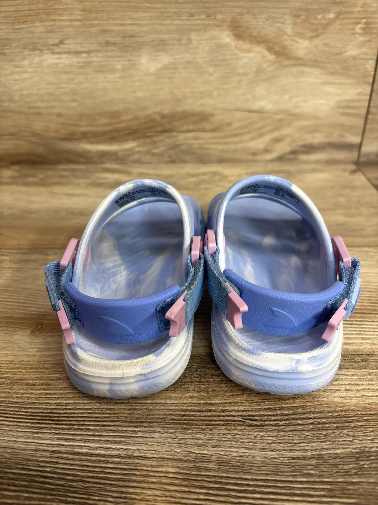 Rear view of Rugged Shark Nature toddler sandals showcasing adjustable heel straps with pink buckles on wooden surface