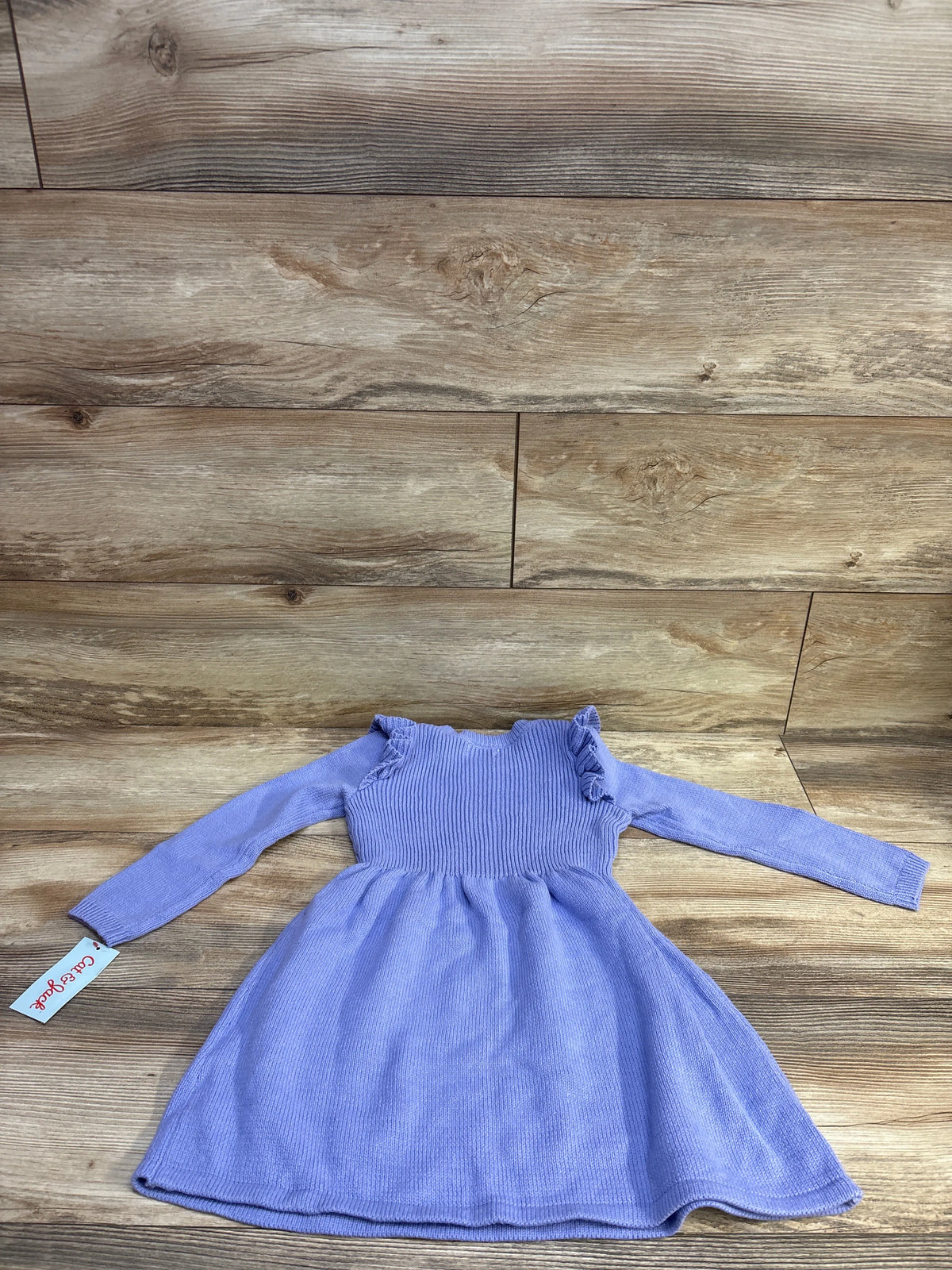 Flat-lay of Cat and Jack purple knit long-sleeve toddler dress size 4T showing ribbed bodice, ruffle shoulder and flared skirt on wood background