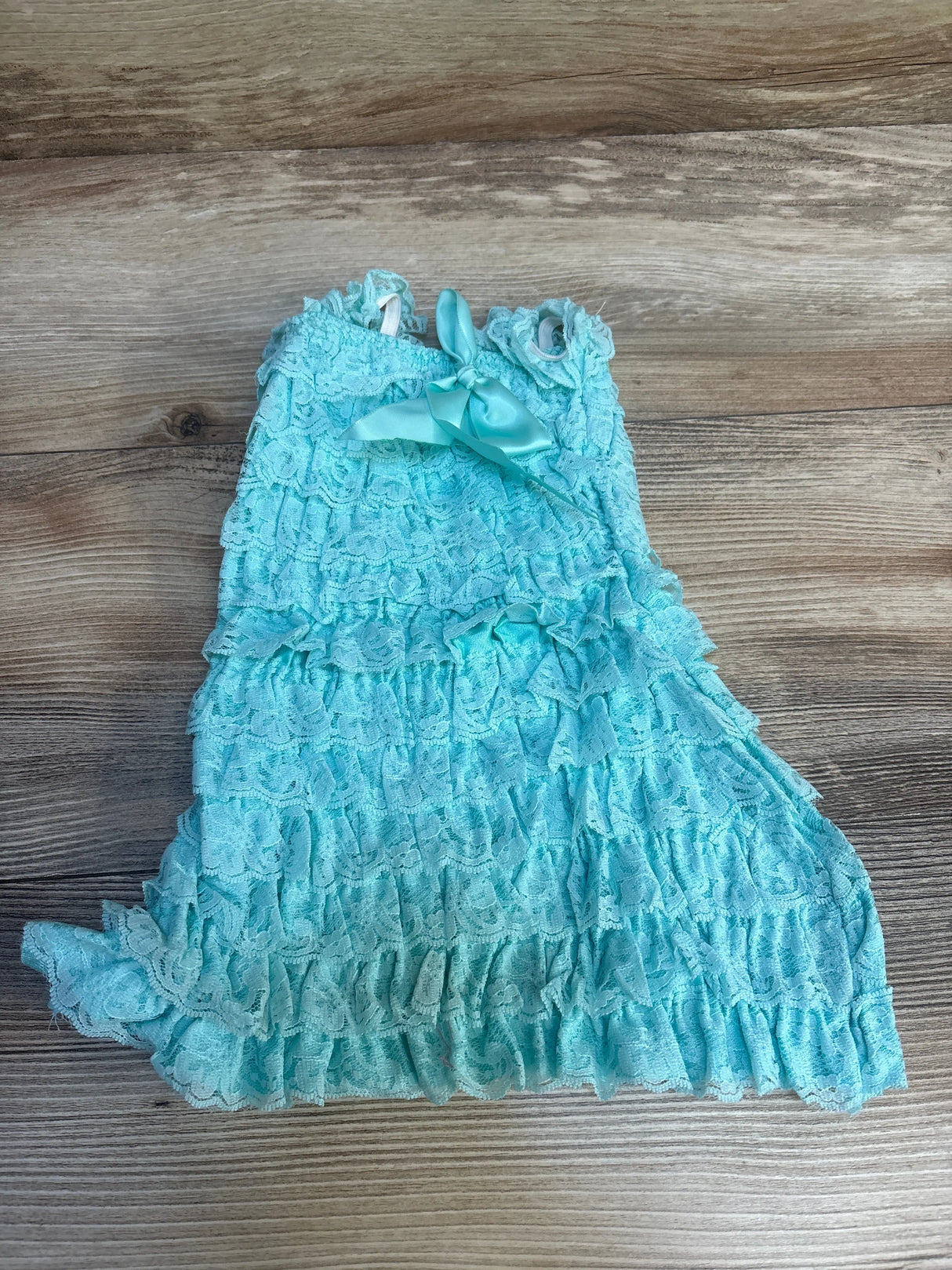 Aqua blue lace ruffle toddler dress with bow on wood background, gently used kids clothing