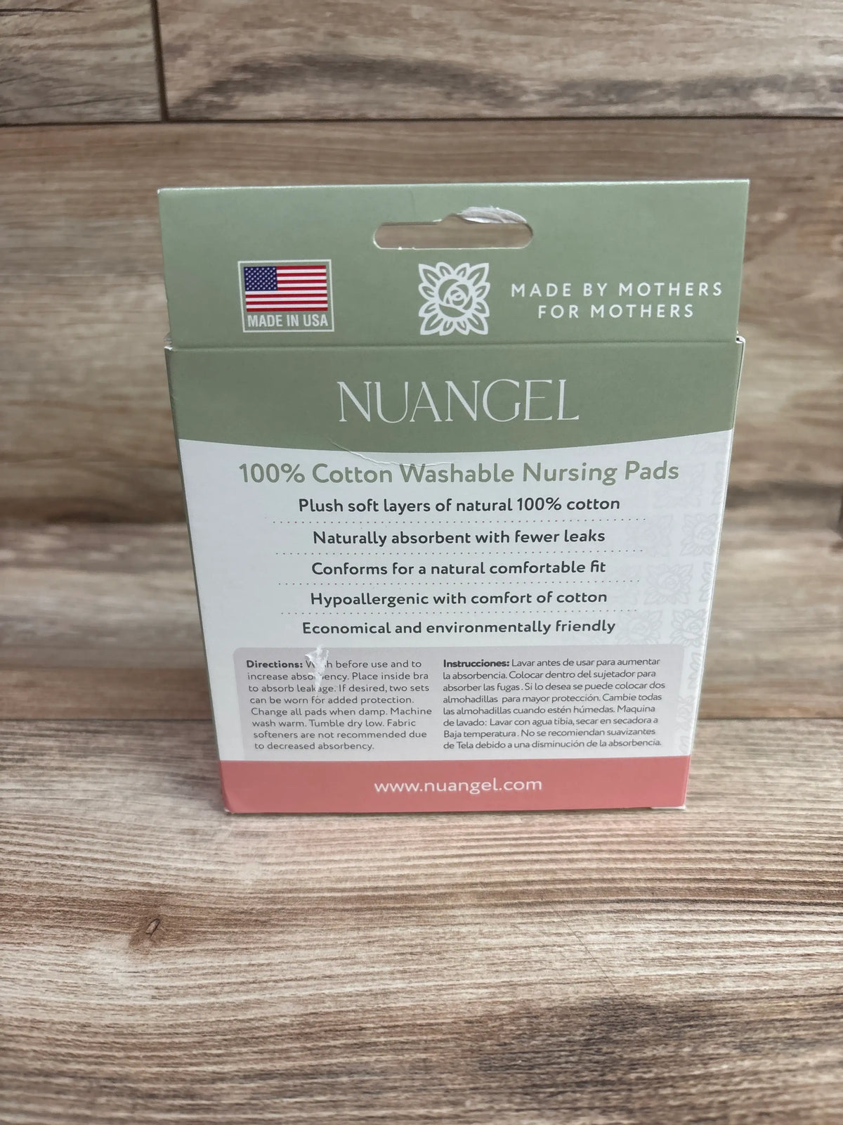 Front view of NuAngel 100% cotton washable nursing pads package showcasing plush cotton layers and absorbency on a wood floor