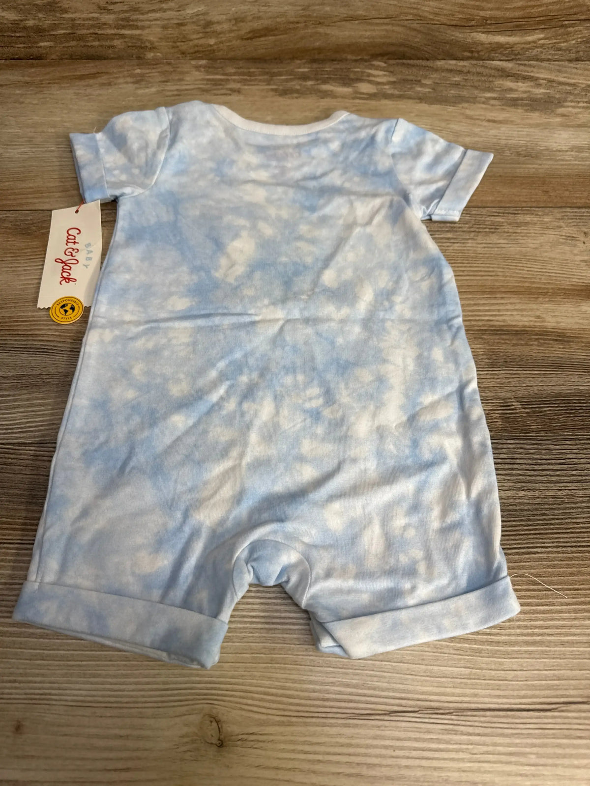 Flat lay of blue Cat & Jack Lil Snuggle Bunny romper, size 3-6 months, with short sleeves and tie-dye pattern