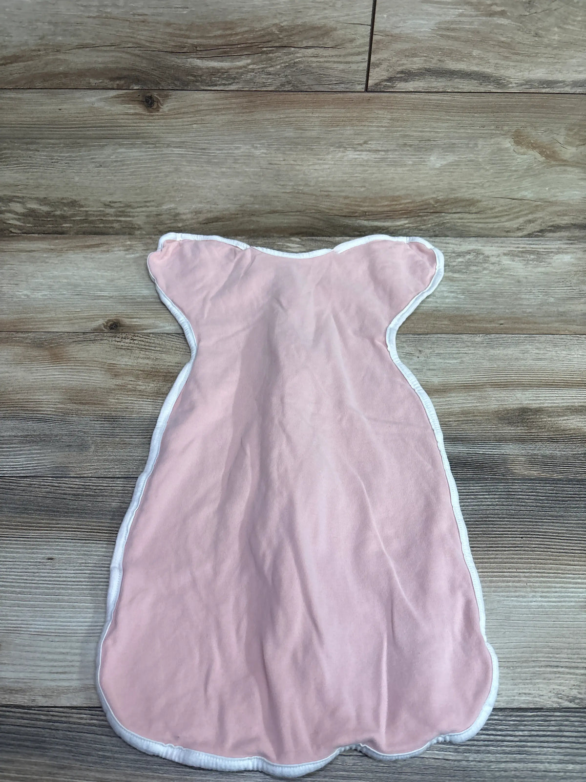 Pink Me n Mommy To Be arms up swaddle for infants size 3-6 months on wood background