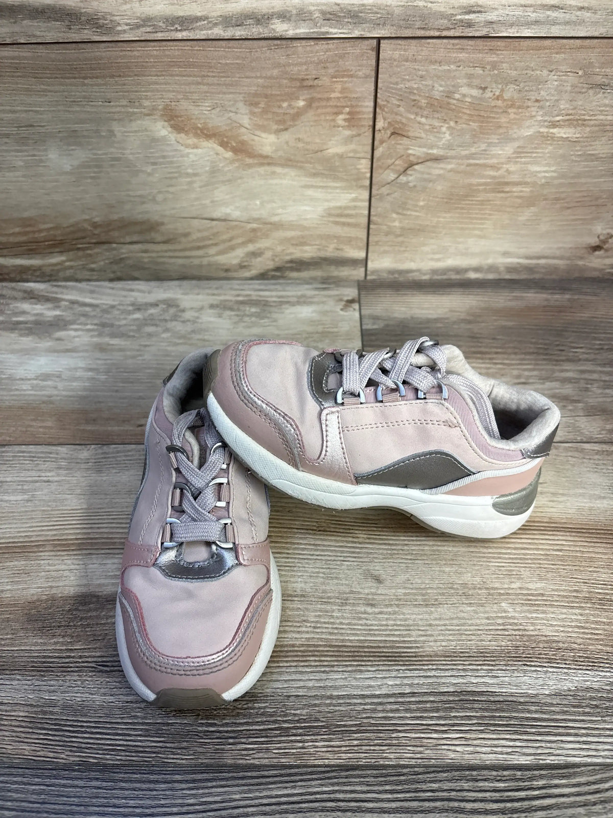 Angled view of Mayoral Makeup sneakers in pink, size 11C, showcasing lace closure on a wood-grain background