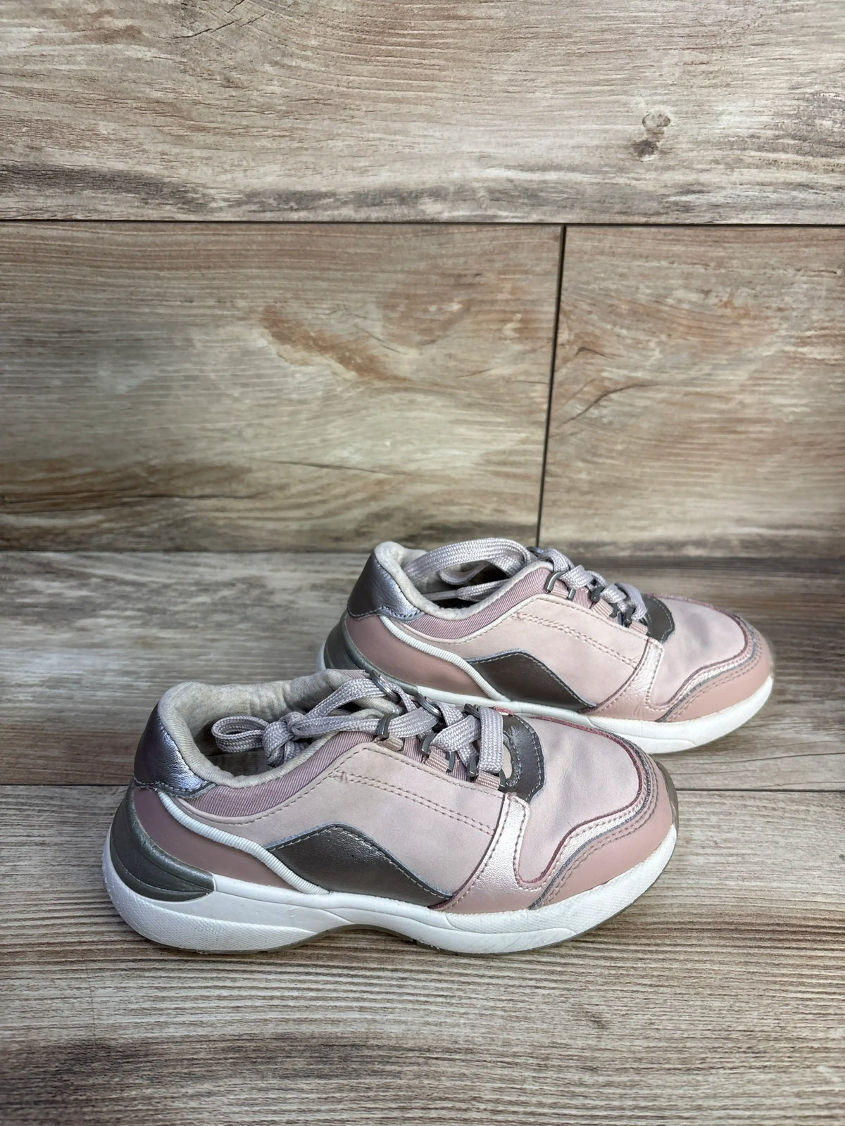 Side view of Mayoral Makeup Sneakers showcasing pink coloring and functional lace closure on a wood-look background