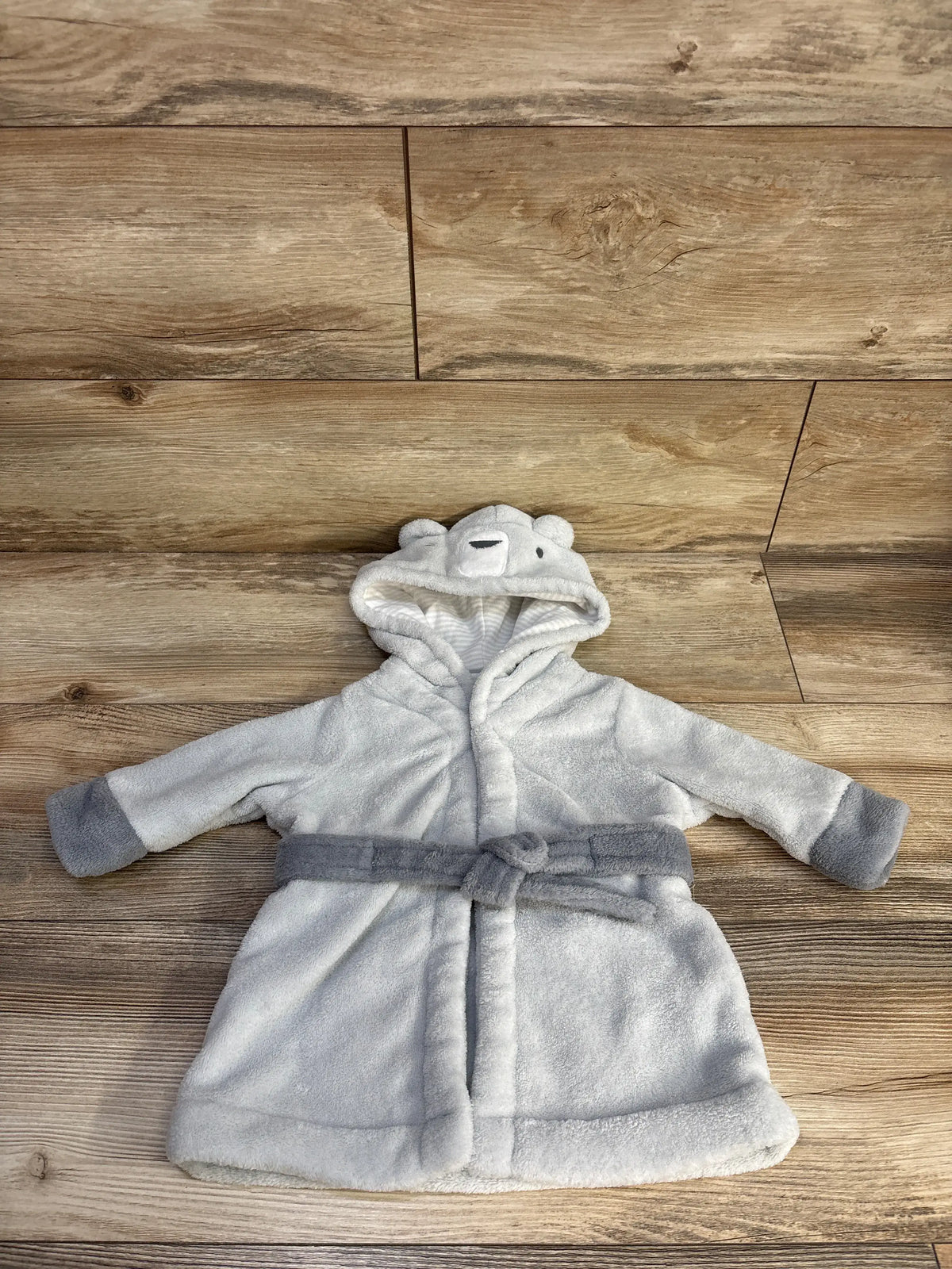 Front view of Cloud Island grey plush bath robe for 6-9 months showcasing hood and tie belt on a wood floor