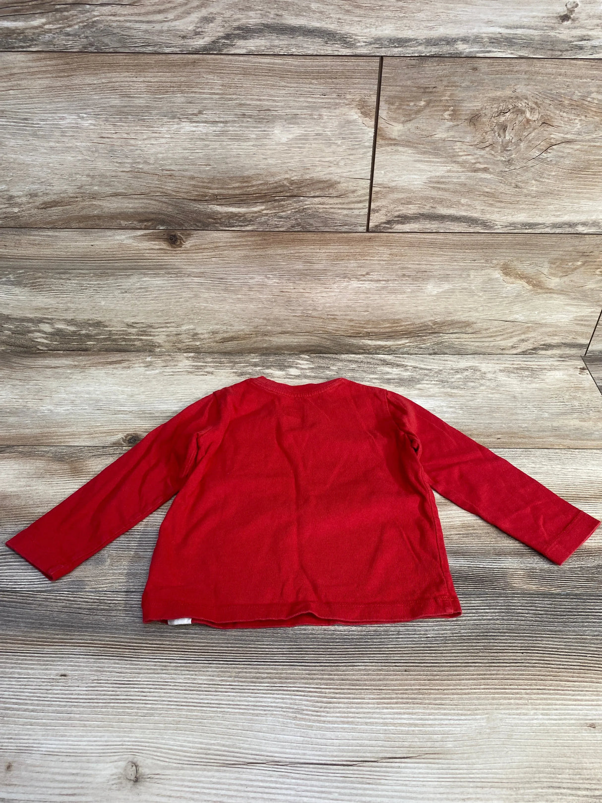 Back flat-lay of Baby Gap red long-sleeve toddler shirt size 2T showing plain back and crew neckline on wood plank background