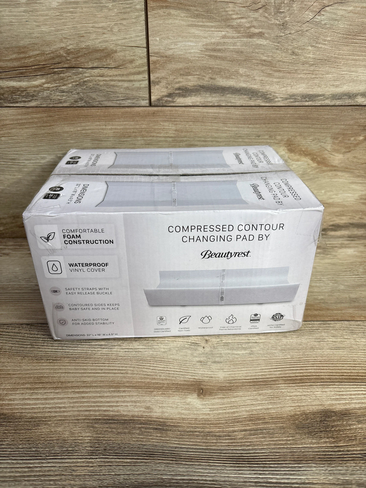 Boxed Beautyrest compressed contour changing pad with waterproof vinyl cover on wood floor
