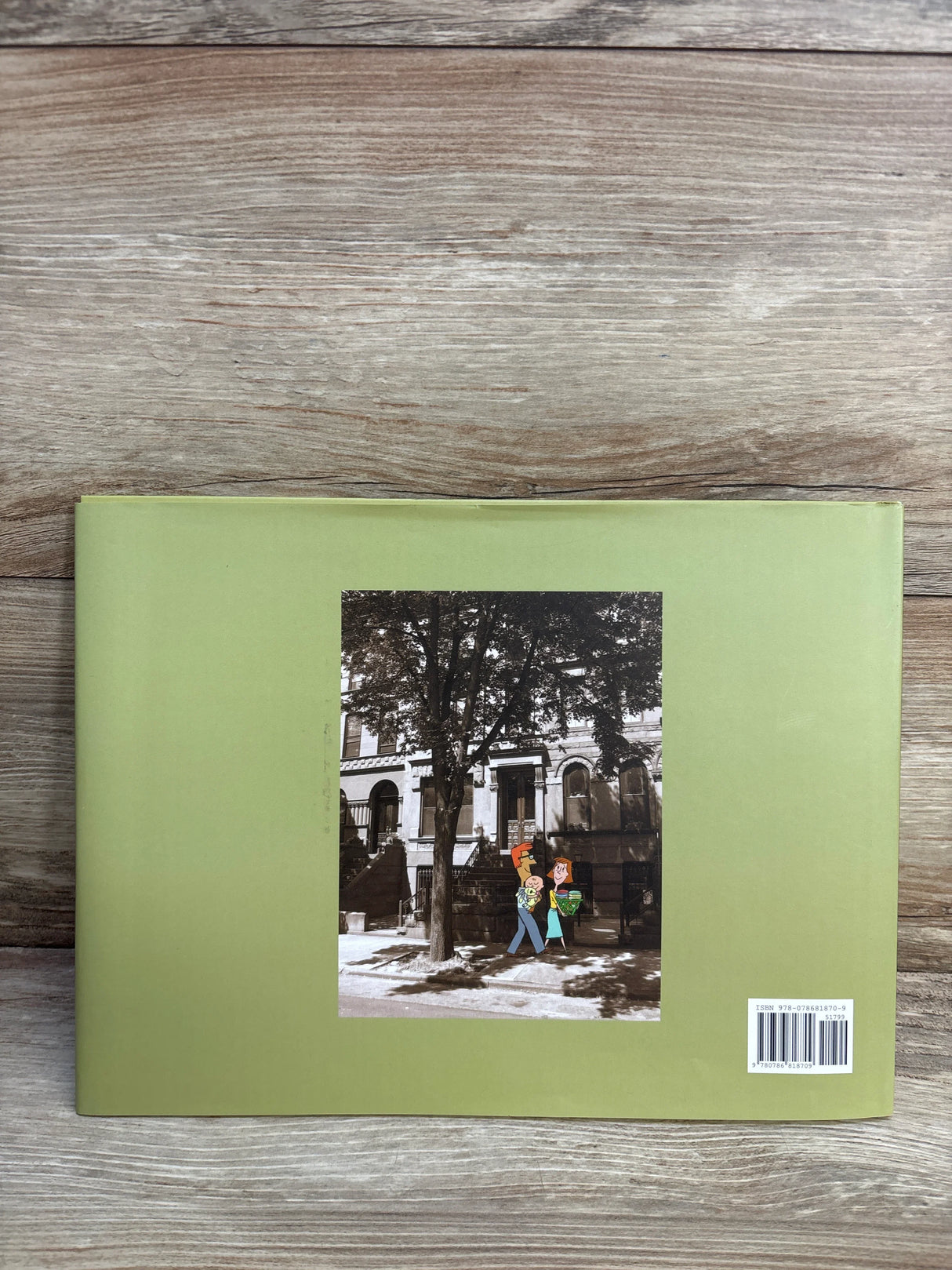 Children's book with green cover, cartoon family illustration, urban background, barcode