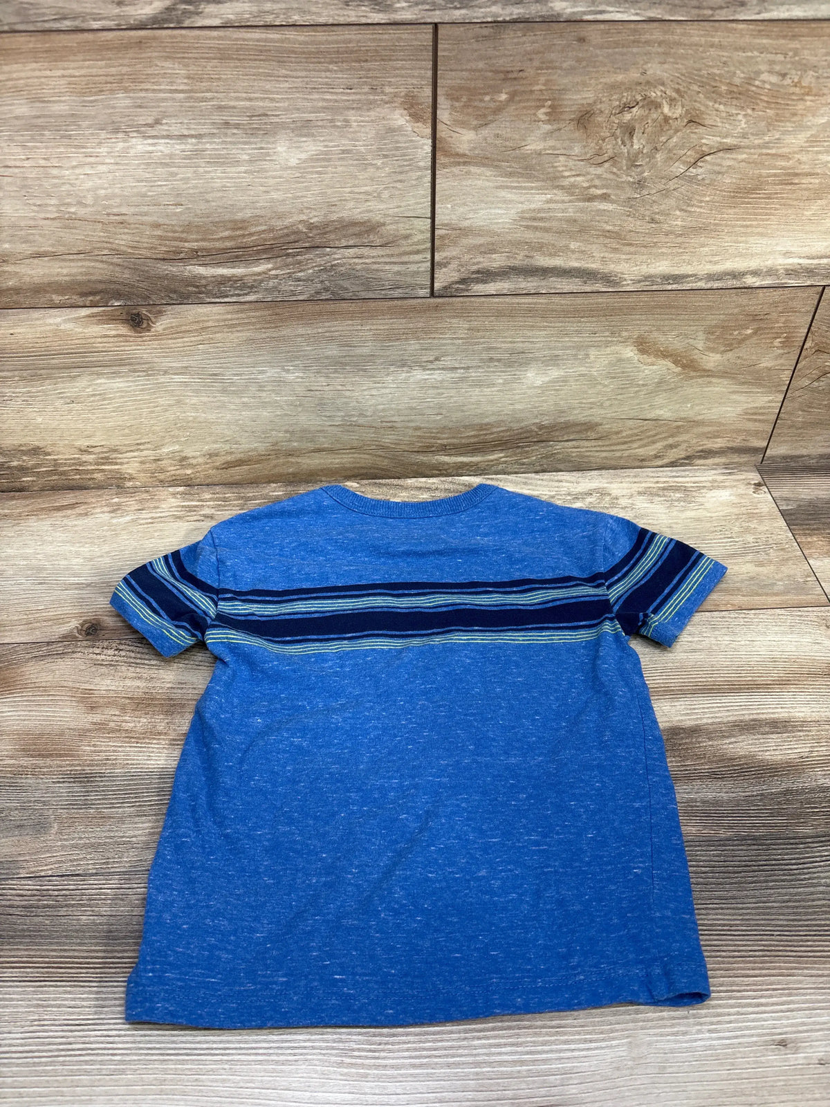 Front view of Cat & Jack striped pocket shirt, size 5T showcasing blue color and horizontal stripes on wood-look background