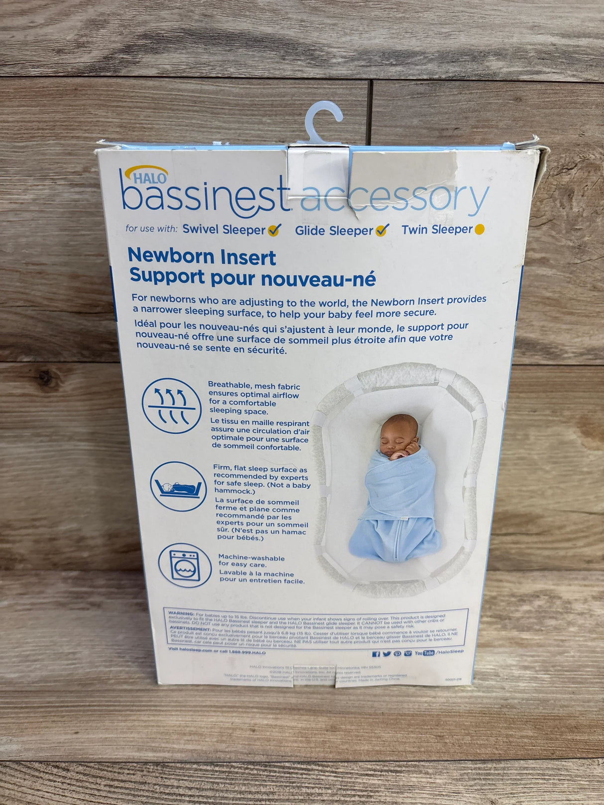 HALO bassinet accessory box for newborn insert with baby image, displayed on wood surface