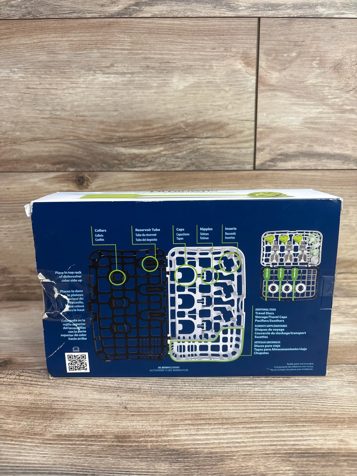 Back view of NEW Dr. Brown’s Dishwasher Basket for Narrow Baby Bottle Parts showcasing blue box with usage diagrams on wood plank floor