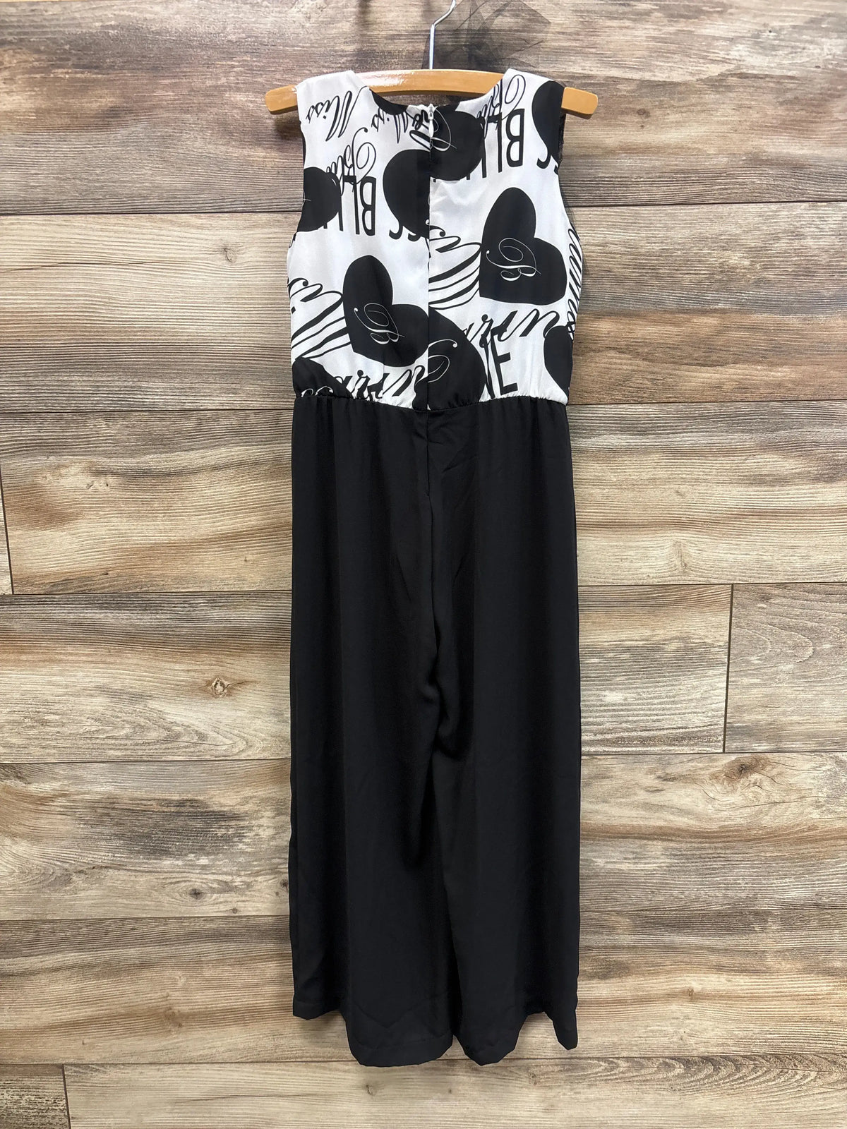 Front view of Miss Bluemarine white tulle sleeveless jumpsuit showcasing wide legs on a wooden background